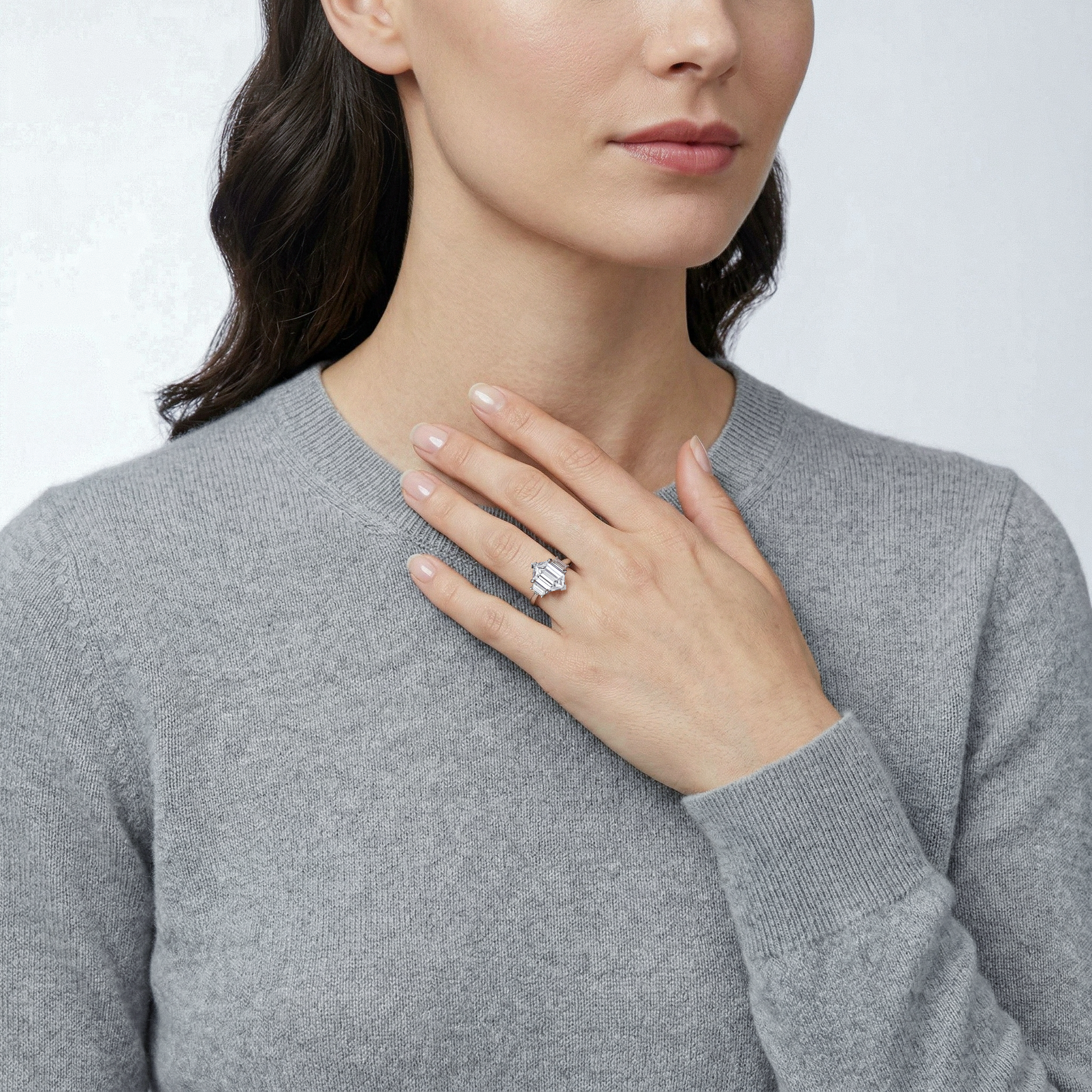 Woman wearing a 3 stones setting style hexagon diamond ring on her hand