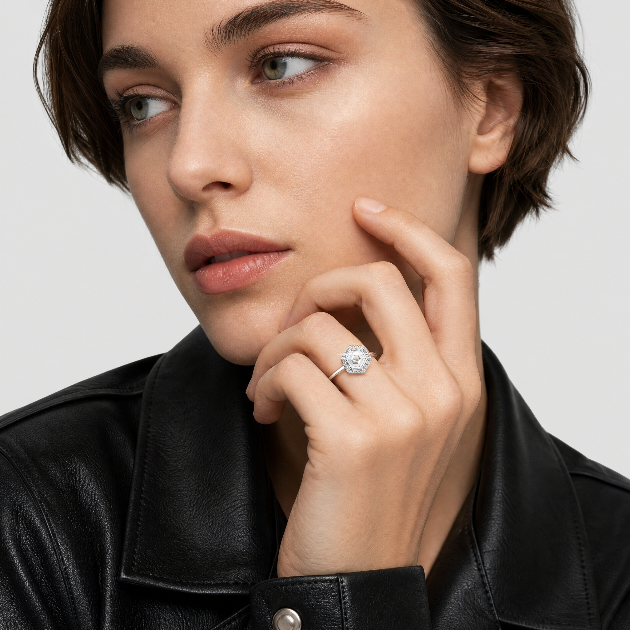 A woman wearing a halo hexagon diamond ring in white gold
