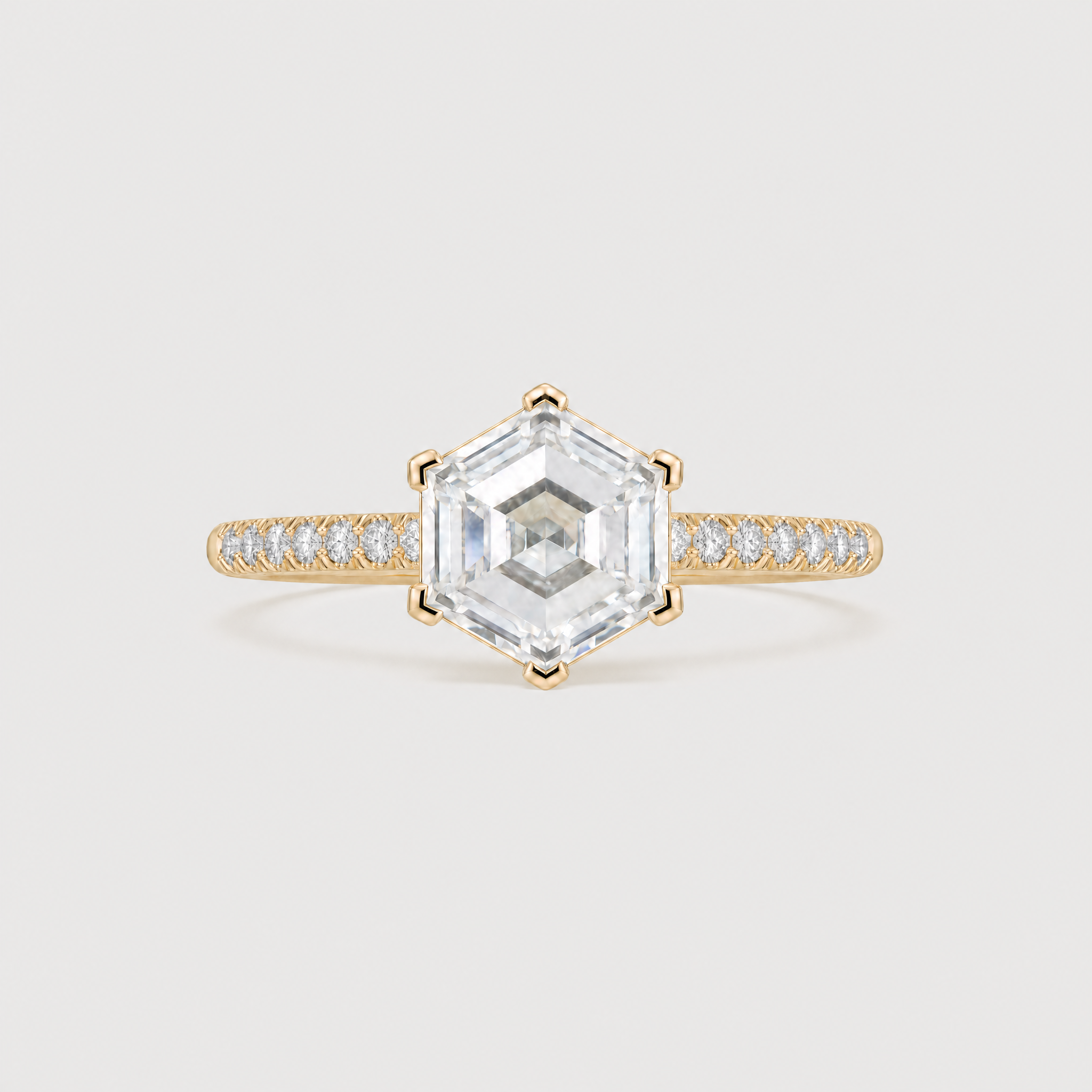 front view of a hexagon diamod ring with pave band in yellow gold