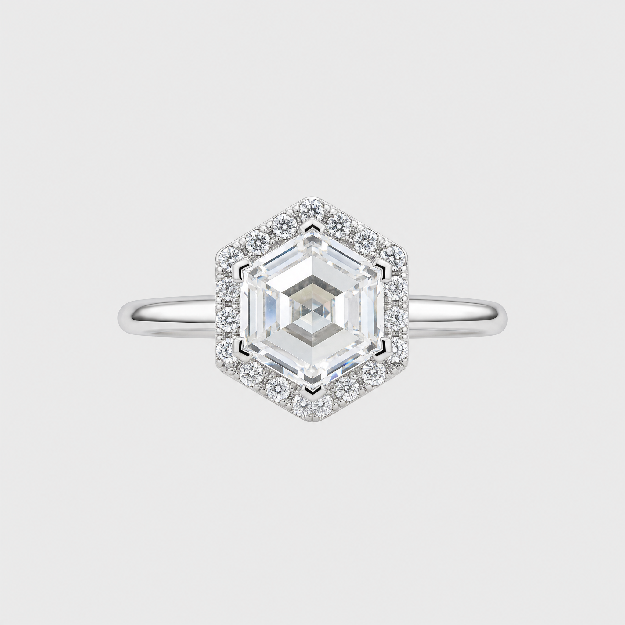 Diamond ring with a hexagonal stone on a light gray background
