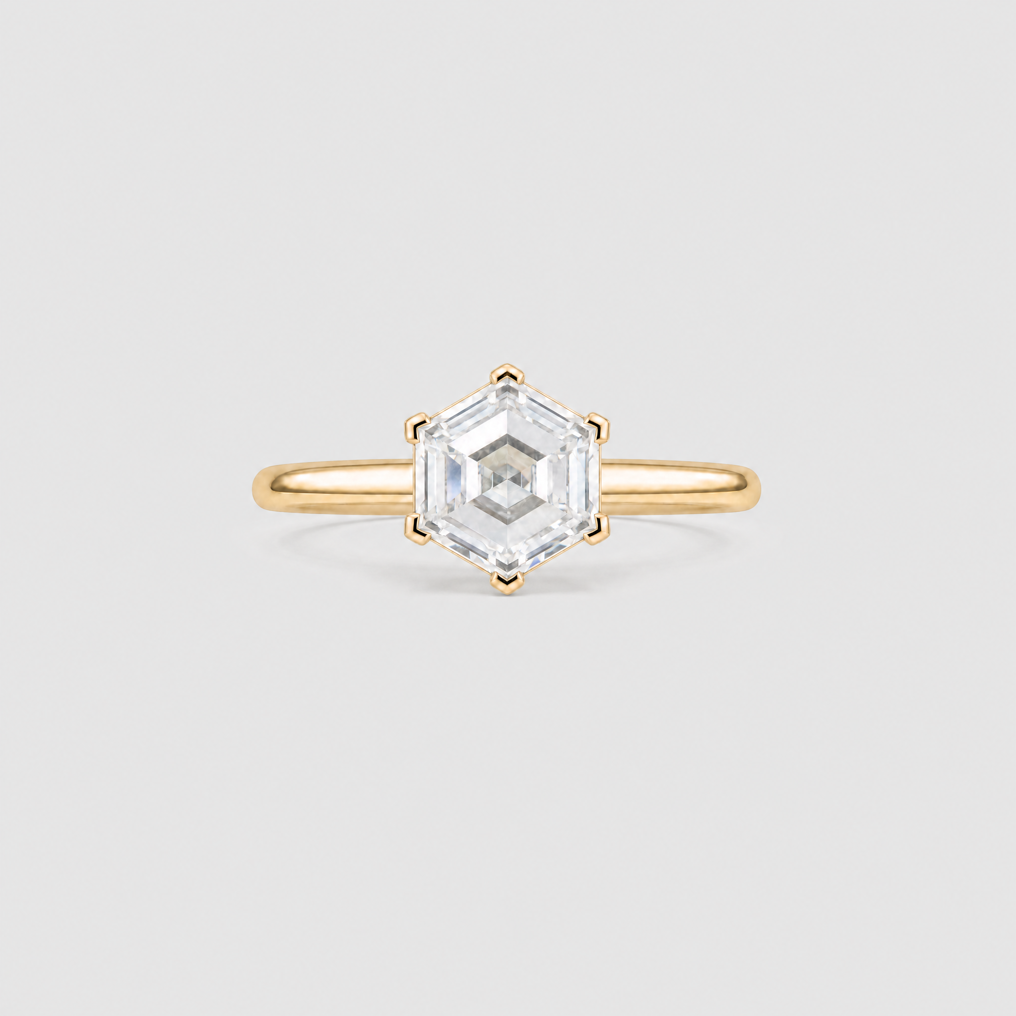 colse up view of hexagon diamond with 6 prong setting ring in yellow gold