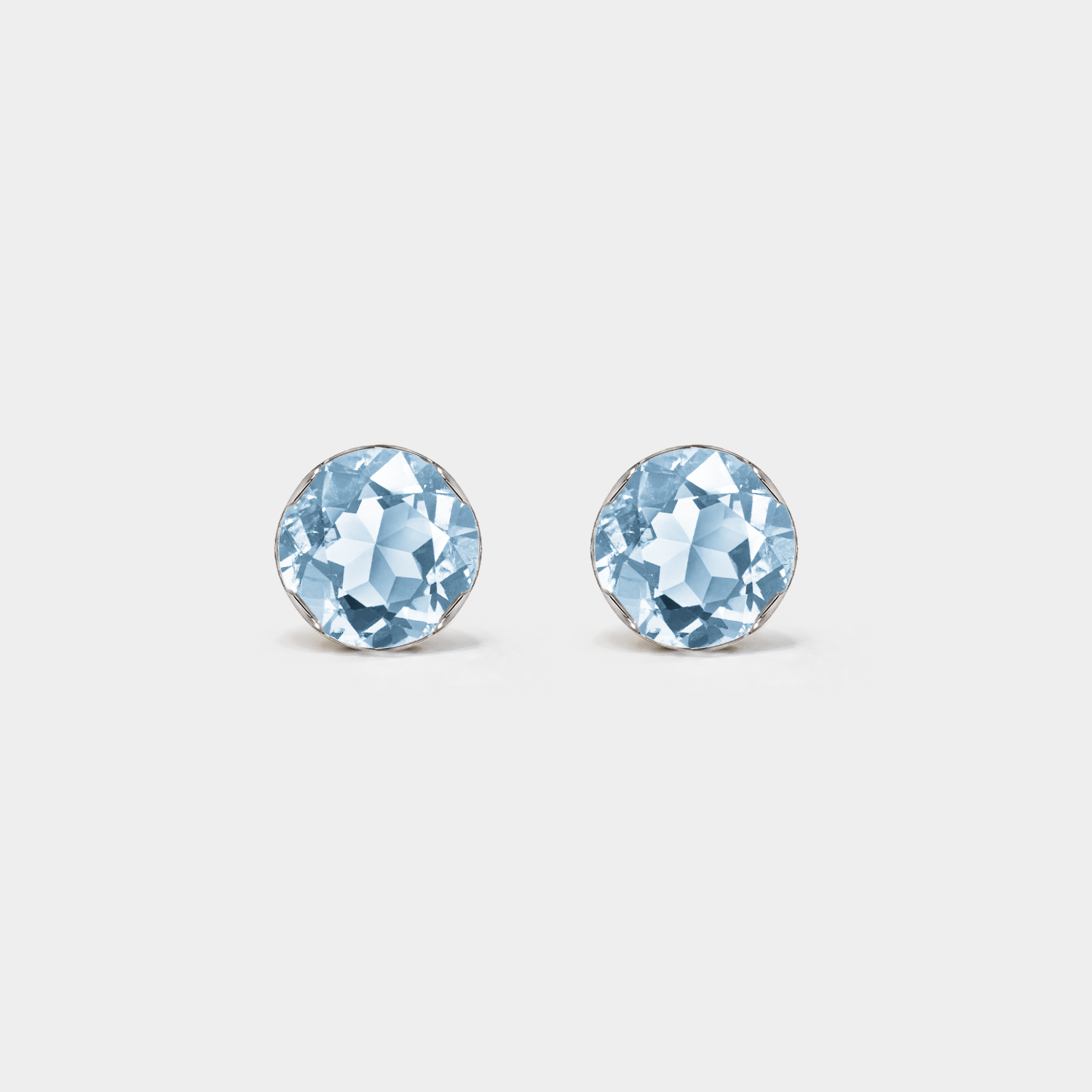 Front view of round lab-grown aquamarine stud earrings in white gold on a white background.