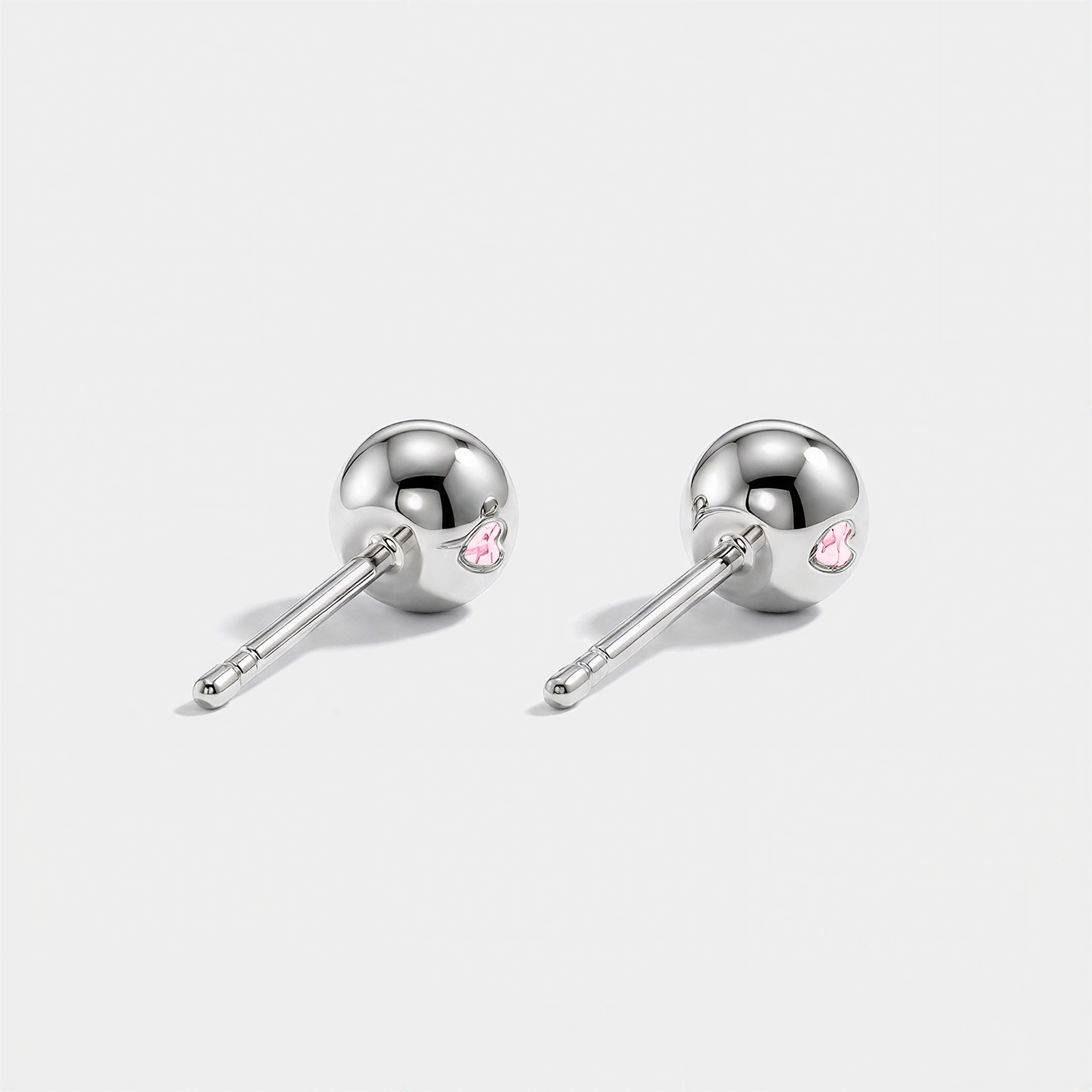 Back view of round pink lab-grown diamond stud earrings with white gold settings and ball backs.