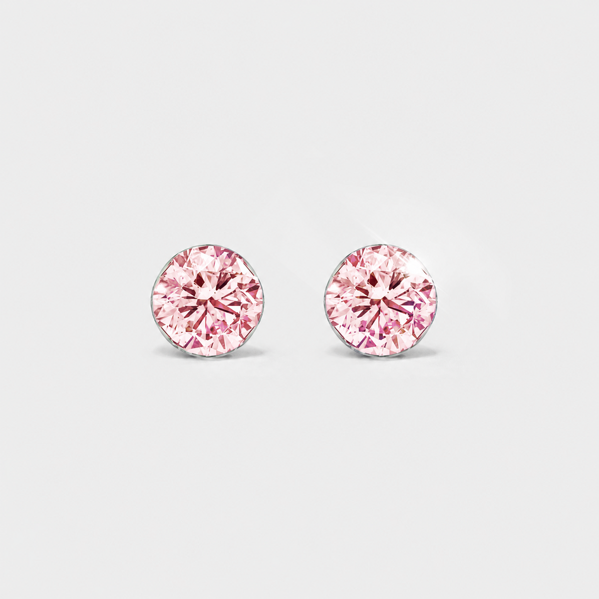 Front view of round pink lab-grown diamond stud earrings in white gold on a white background.