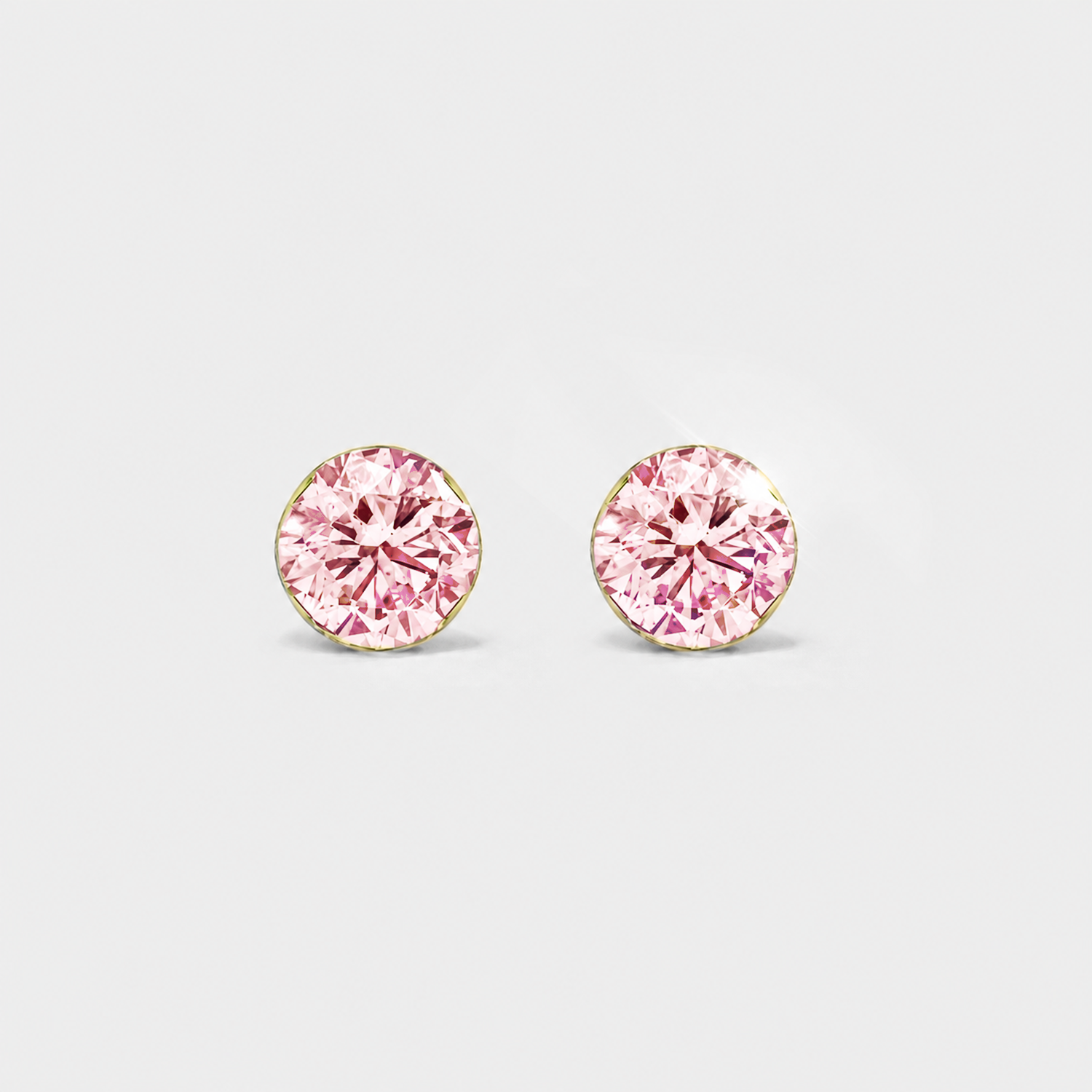 Front view of round pink lab-grown diamond stud earrings in yellow gold on a white background.