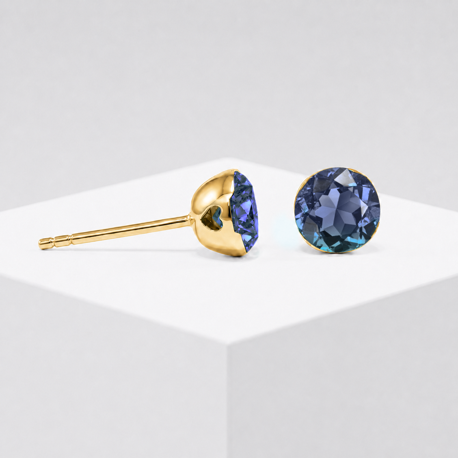 Round lab-grown alexandrite stud earrings shown from the front and side in yellow gold.