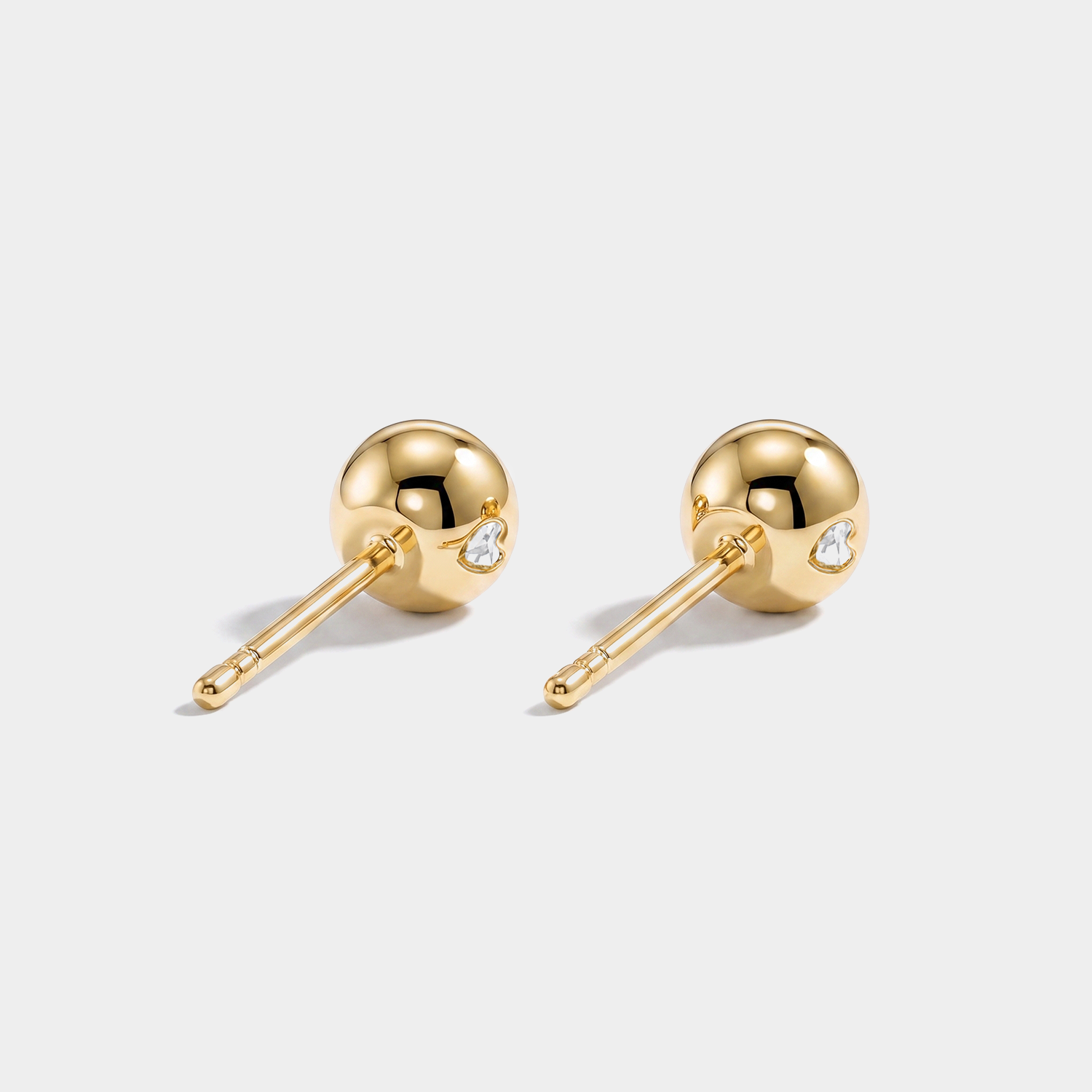 Round stone stud earrings in yellow gold, back view