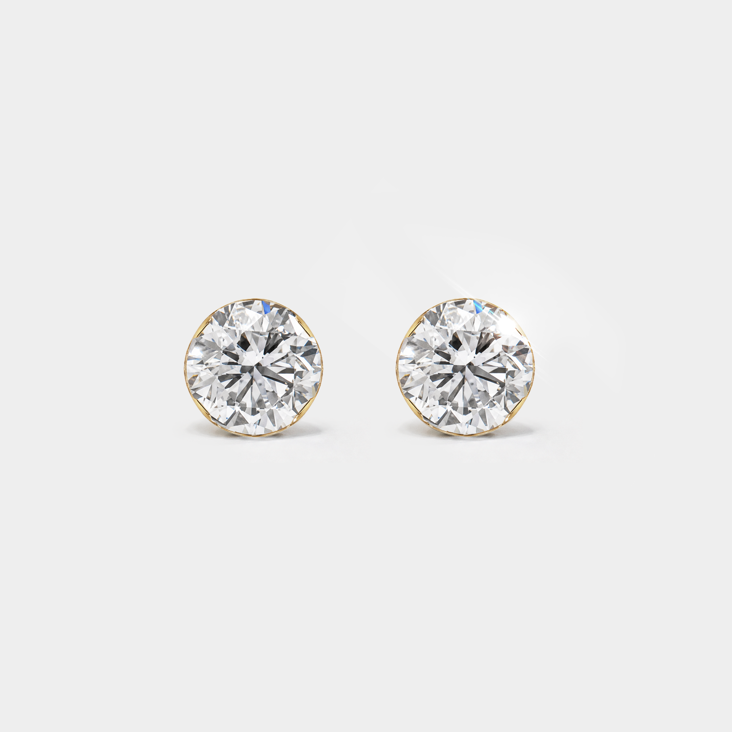 Round diamond stud earrings in yellow gold, front view