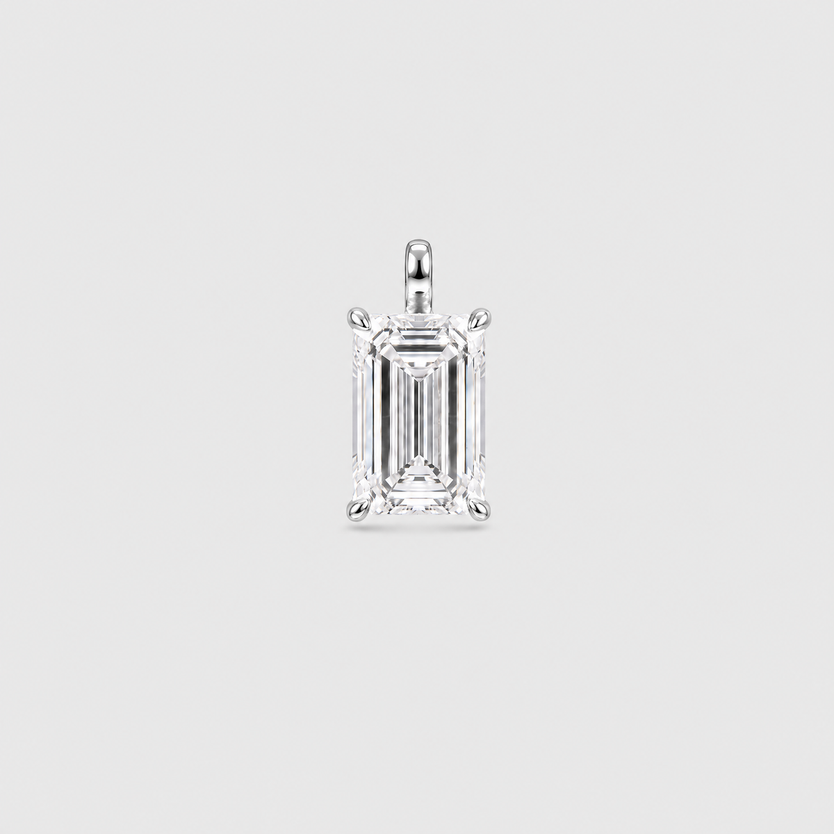 Front view of an emerald-cut solitaire pendant in white metal with a four-prong setting.