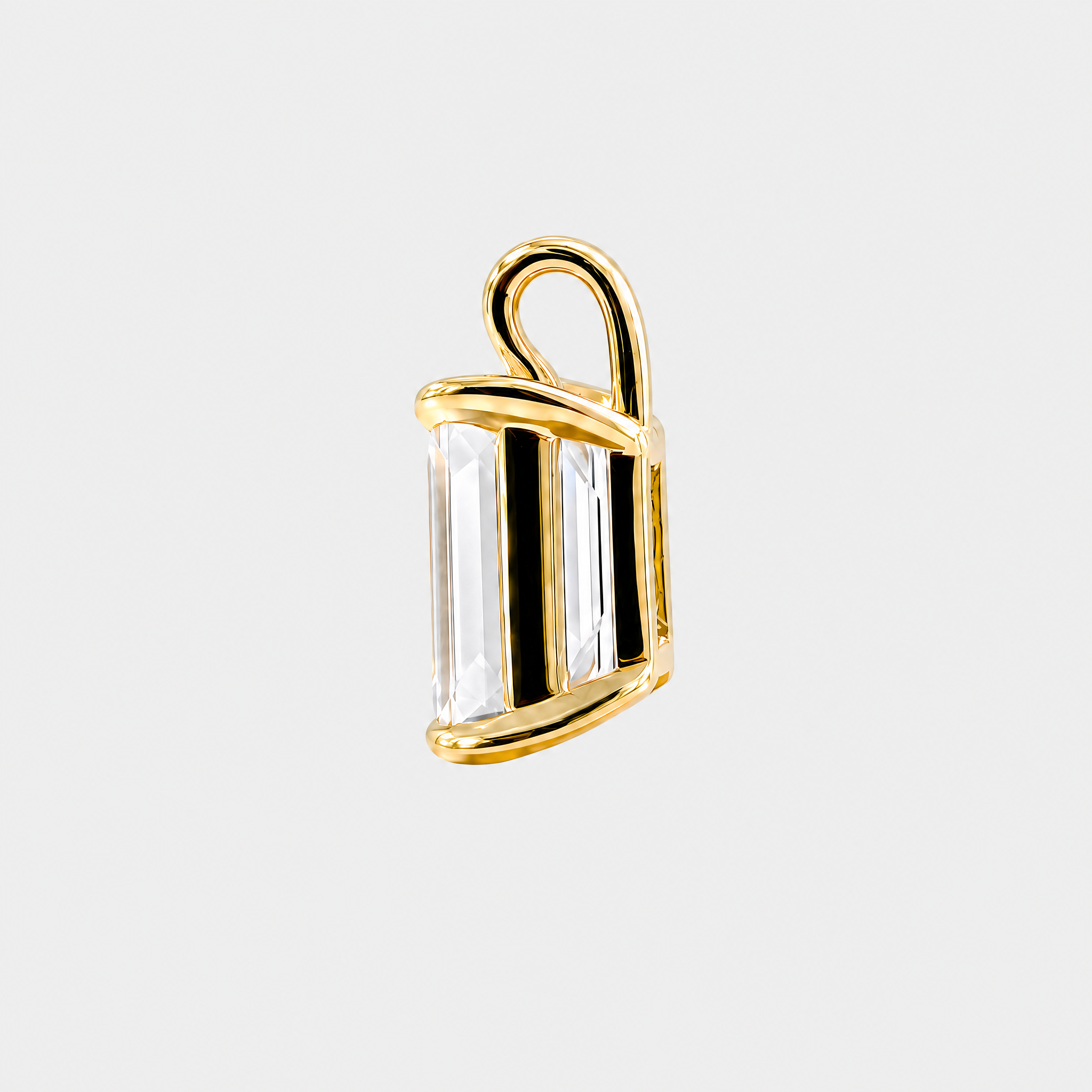Side view of an emerald-cut solitaire pendant in yellow gold showing the open setting and bail.