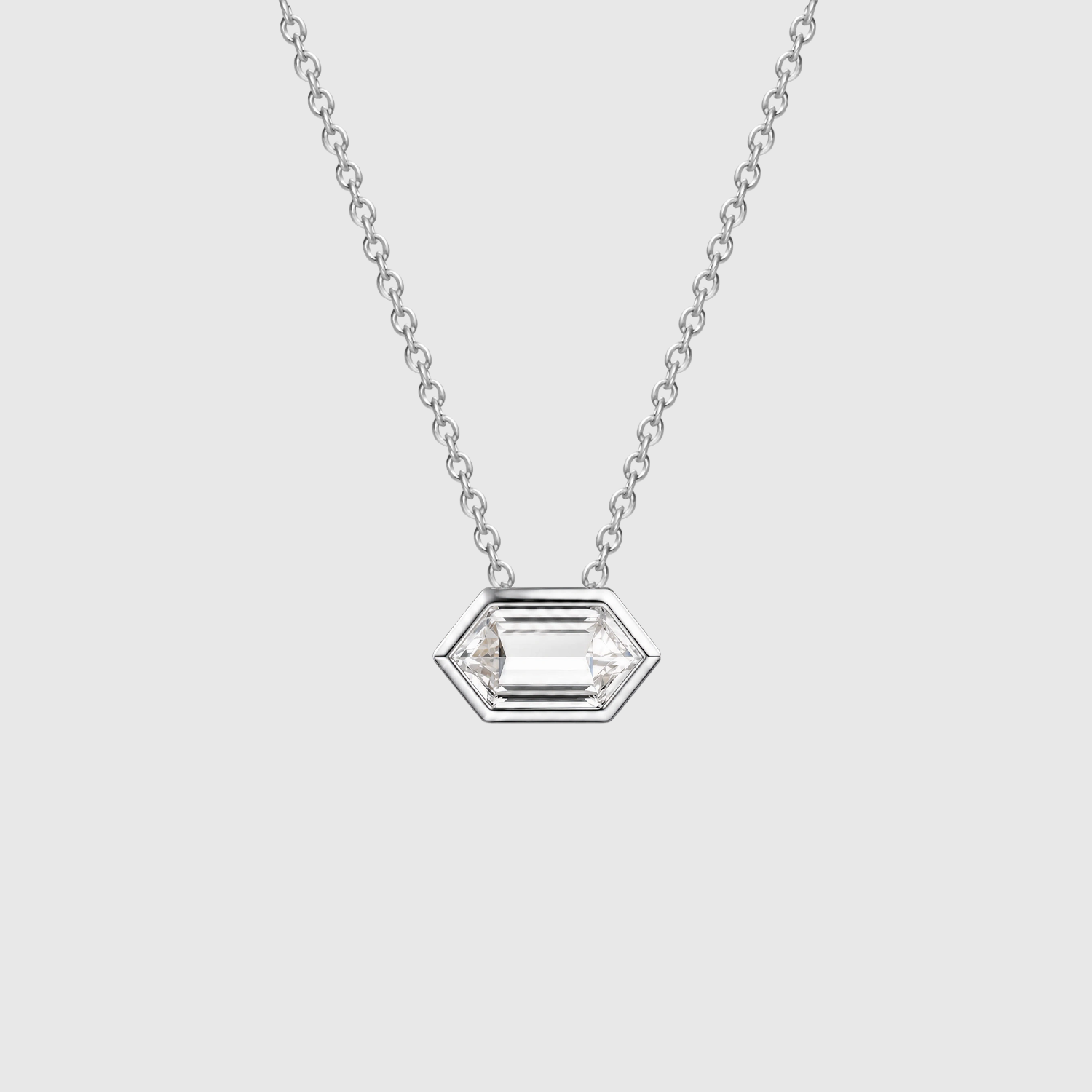 Front view of an elongated hexagon-cut diamond pendant in white gold displayed on a fine chain.