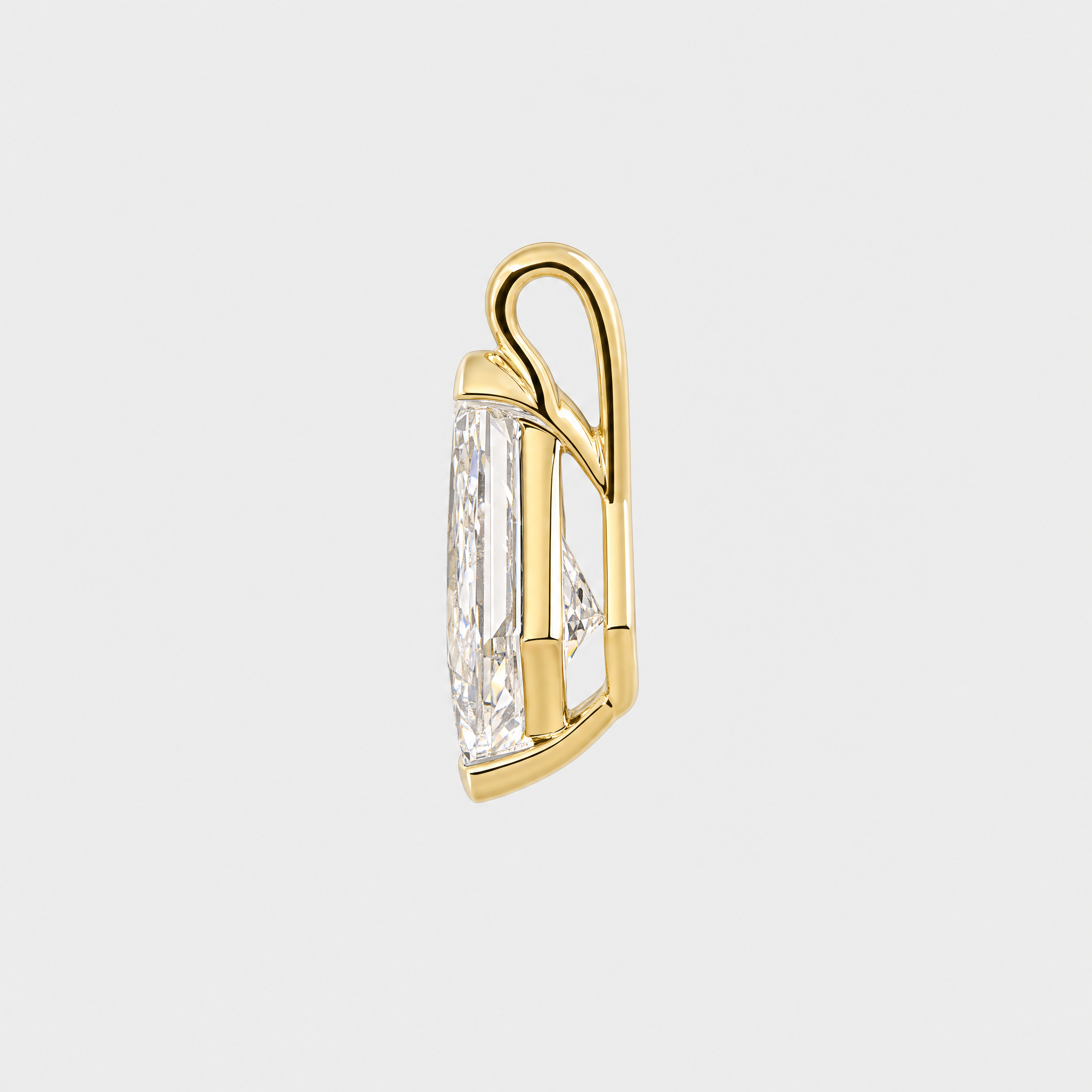 Side view of a kite-cut solitaire pendant in yellow gold showing the open setting and bail.