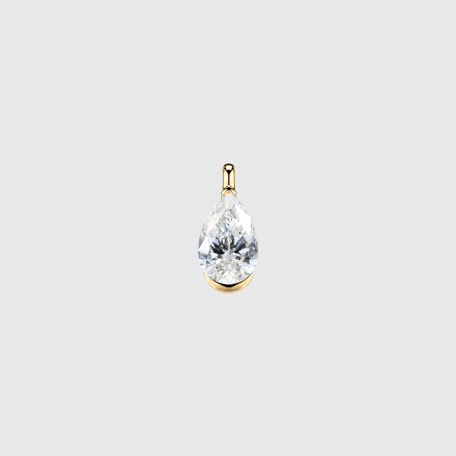 Front view of a pear-cut diamond pendant in yellow gold with a half-bezel setting.