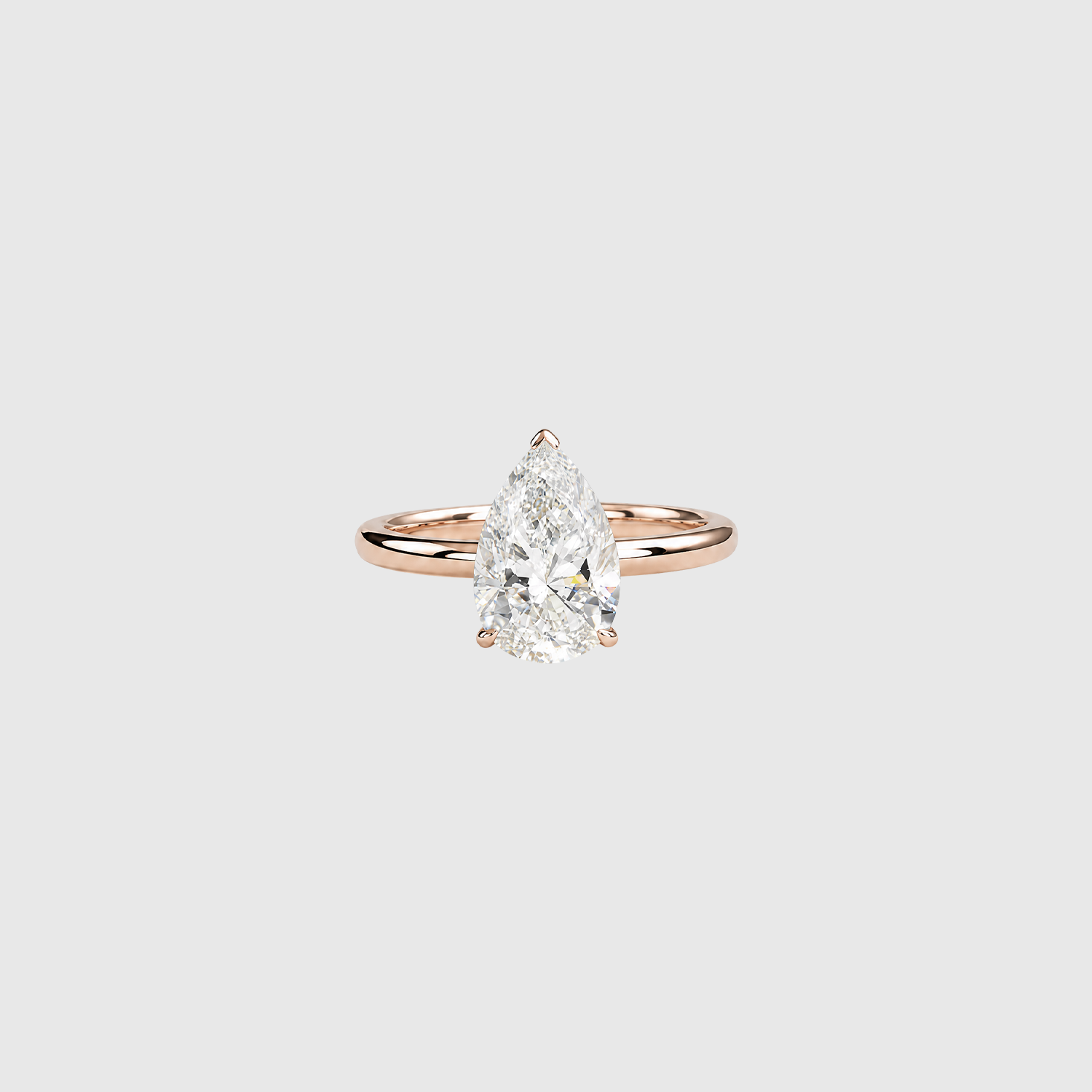 Pear-shaped lab-grown diamond solitaire engagement ring in rose gold, front view.