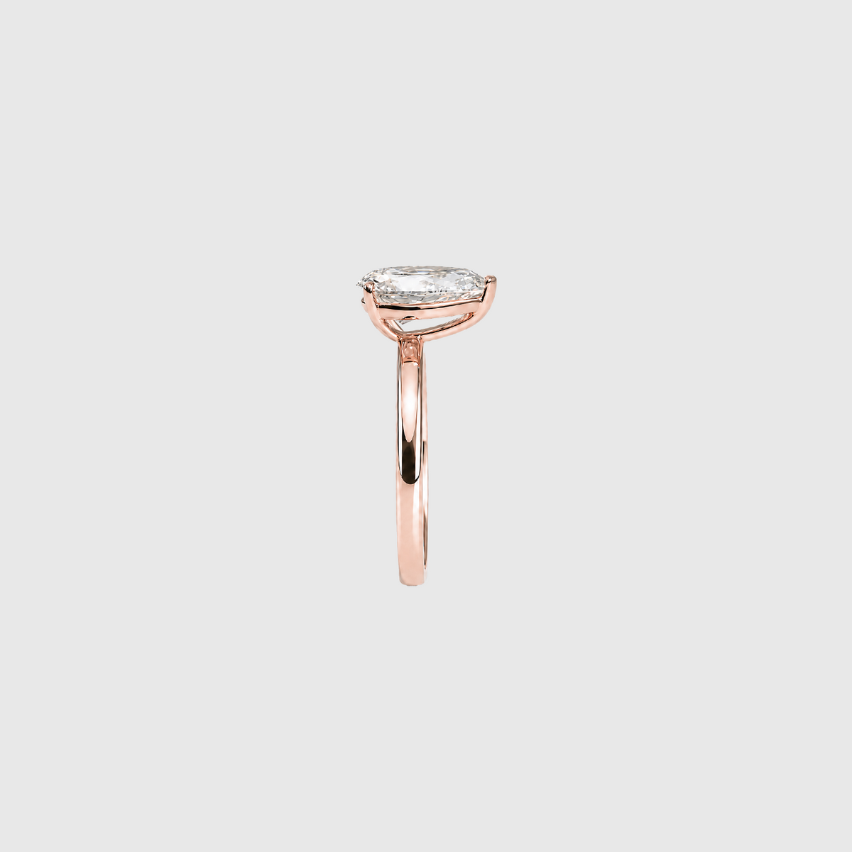 Pear-shaped lab-grown diamond solitaire engagement ring in rose gold, side view.