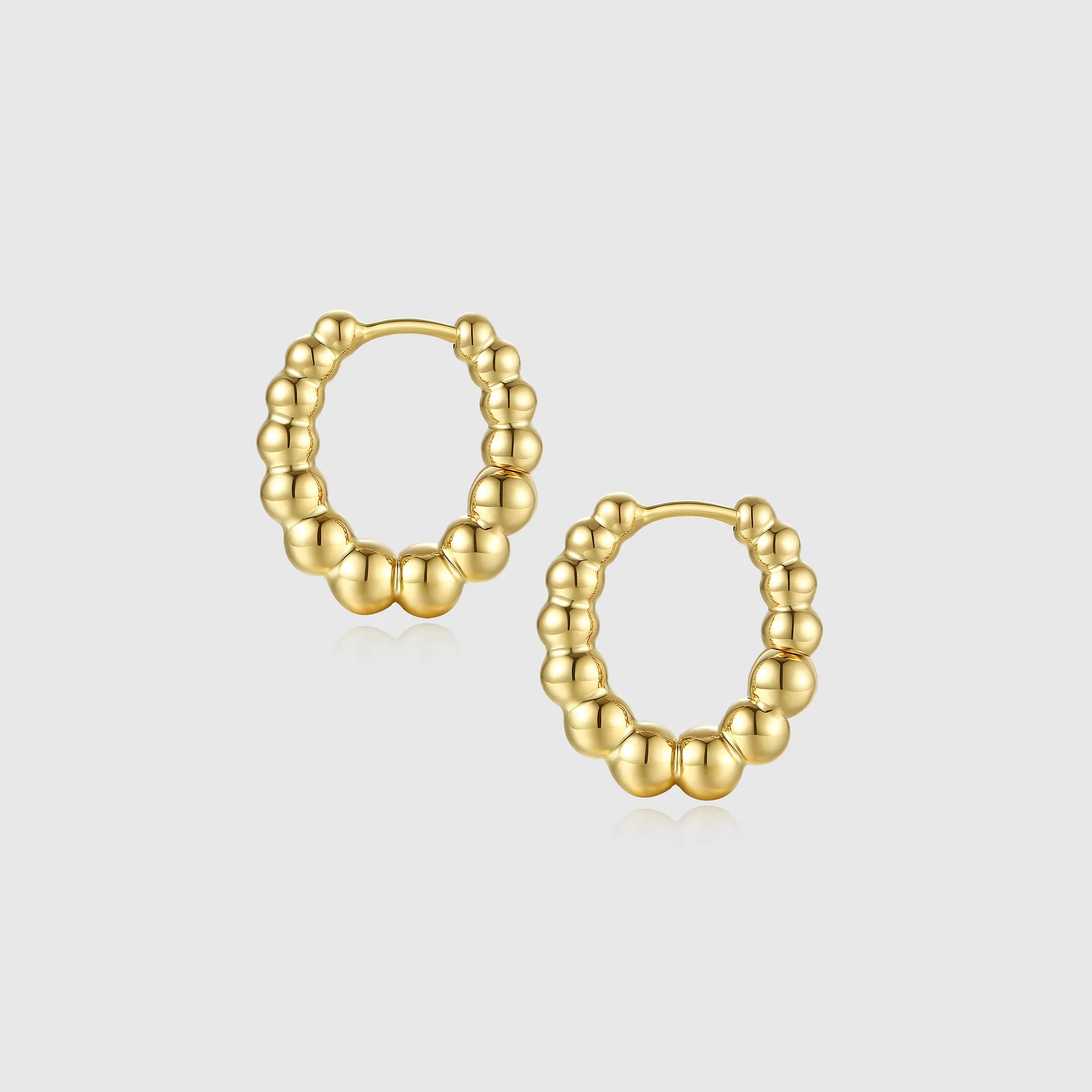 Gold beaded oval hoop earrings for women