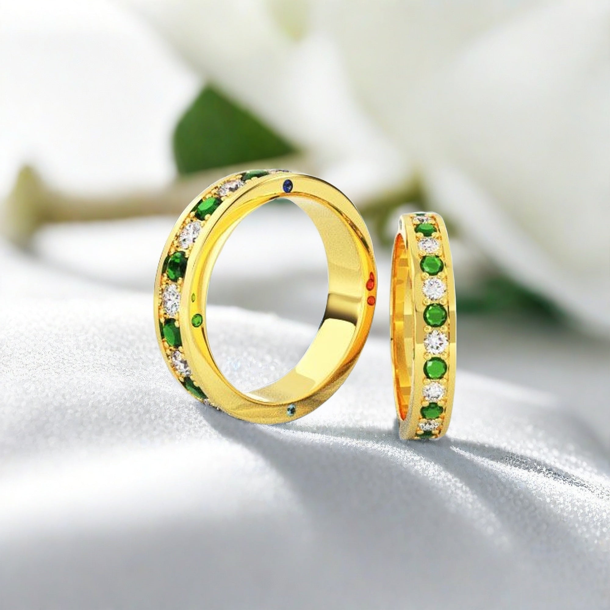 Emerald and Diamond Eternity Ring. Gold band with green gemstones and diamonds.