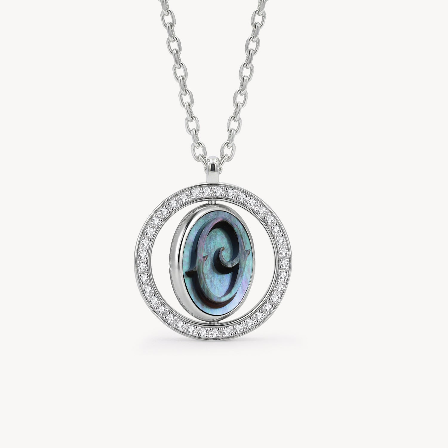 Reversible personalized initial diamond necklace with a black mother-of-pearl background, shown on a 925 sterling silver chain.