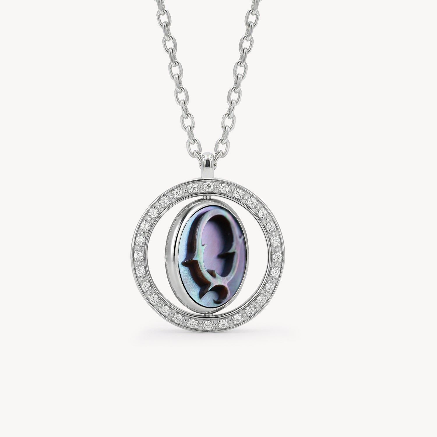 Reversible personalized initial diamond necklace with a black mother-of-pearl background, shown on a 925 sterling silver chain.