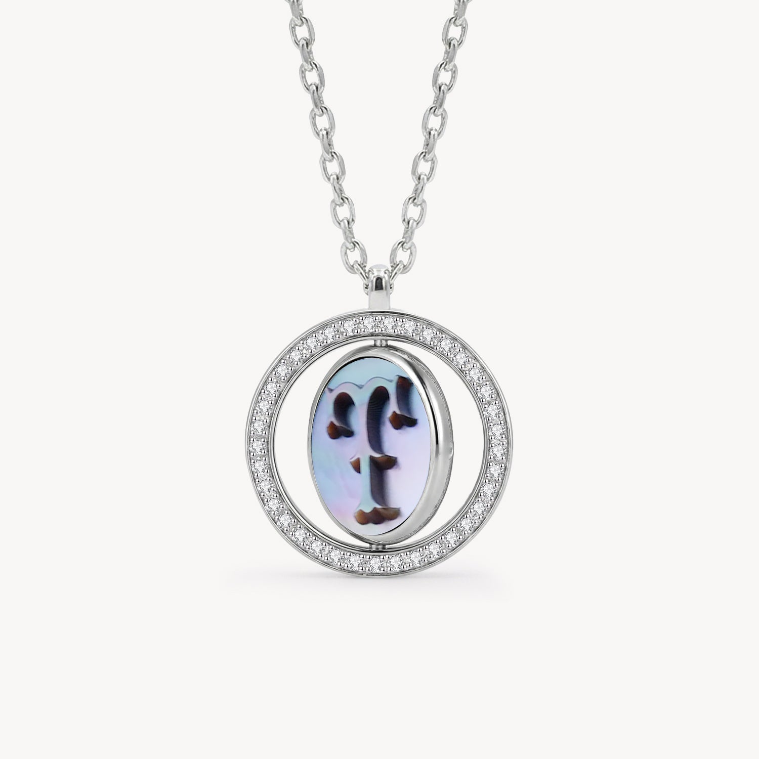 Reversible personalized initial diamond necklace with a black mother-of-pearl background, shown on a 925 sterling silver chain.
