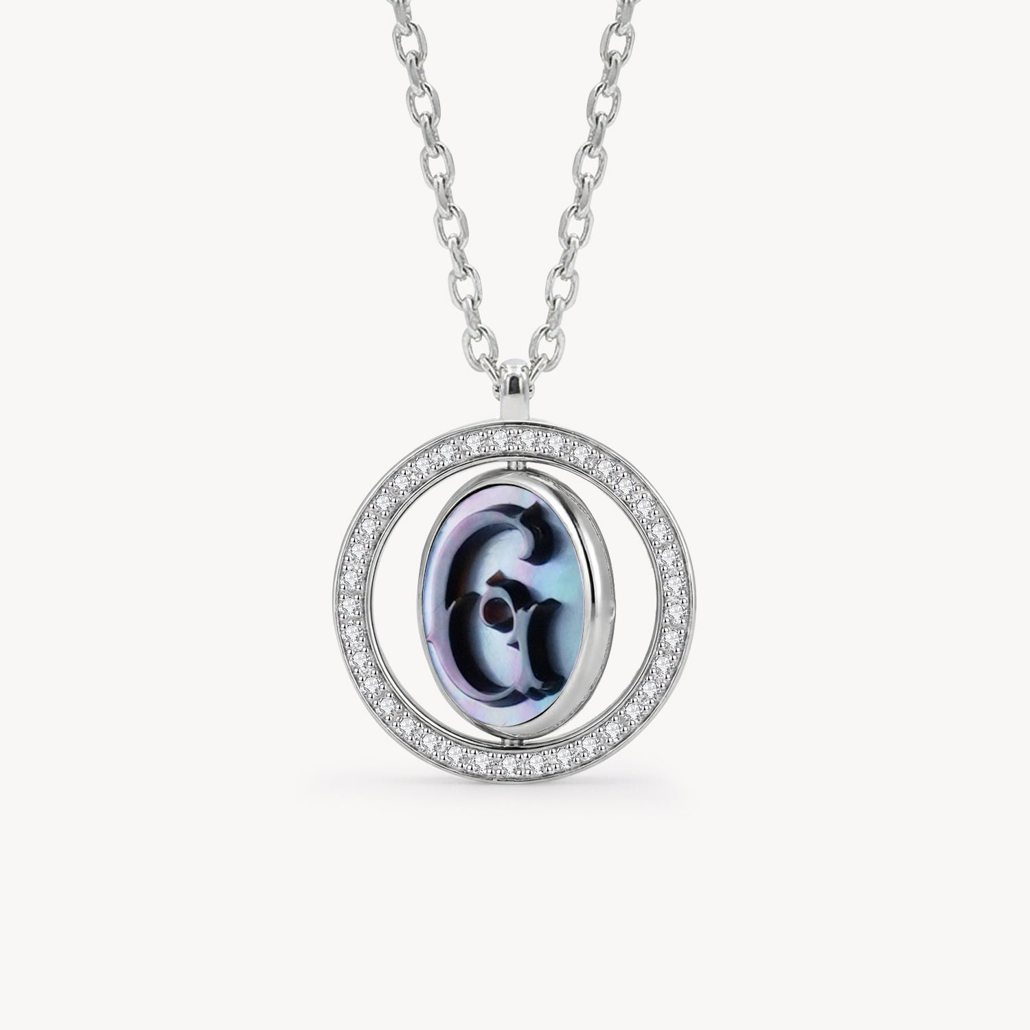 Reversible personalized initial diamond necklace with a black mother-of-pearl background, shown on a 925 sterling silver chain.