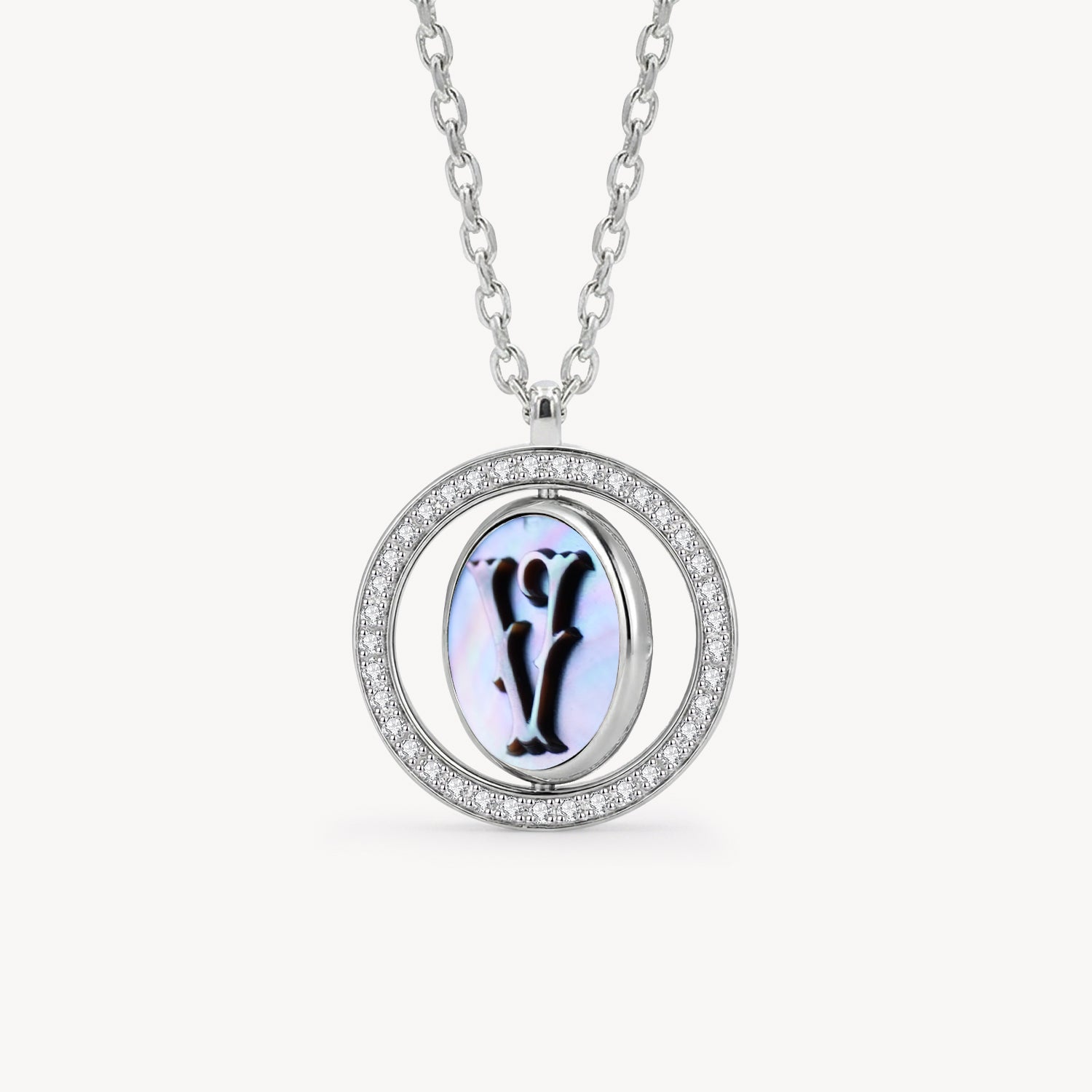 Reversible personalized initial diamond necklace with a black mother-of-pearl background, shown on a 925 sterling silver chain.