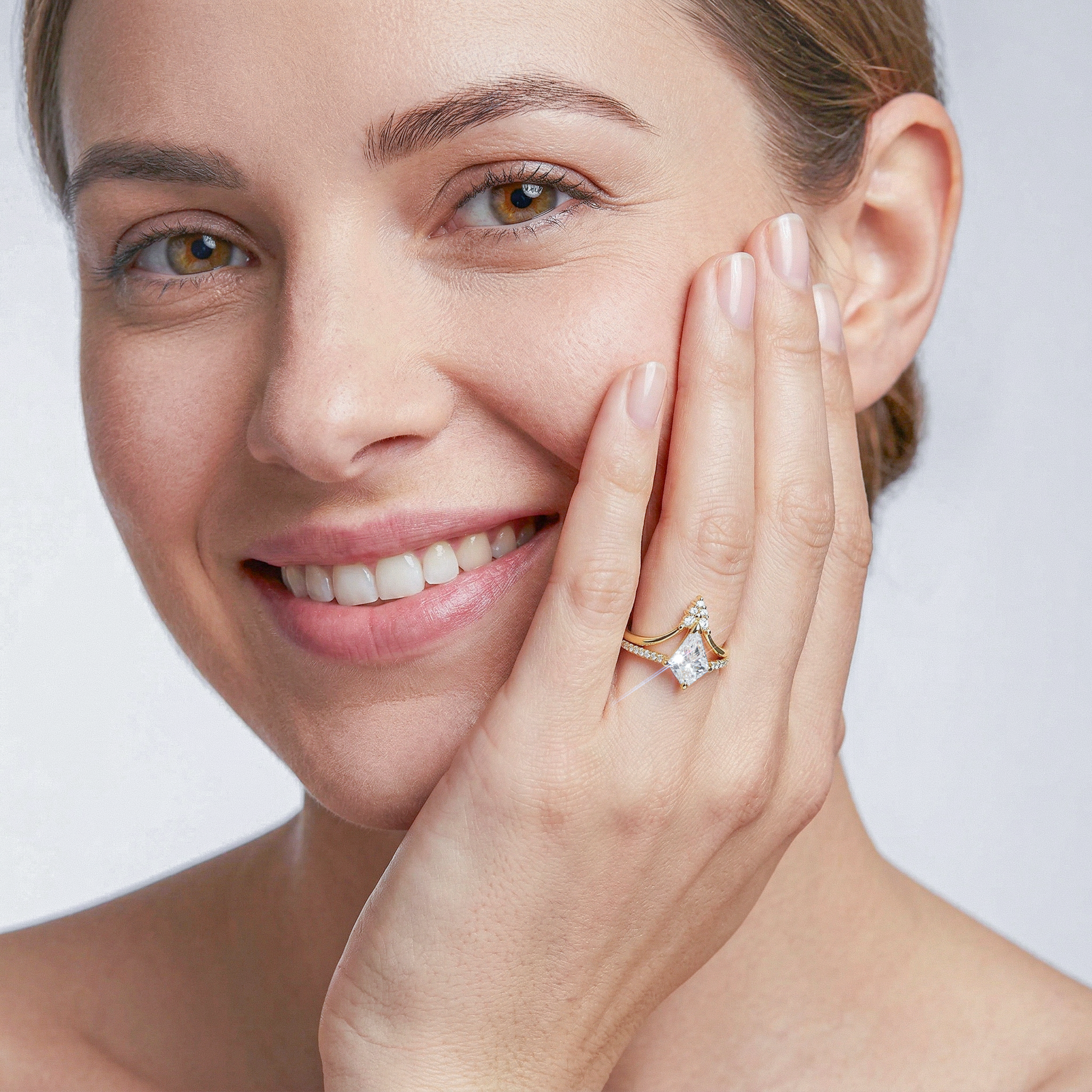 Woman wearing kite shape diamond golden ring sets on a white background
