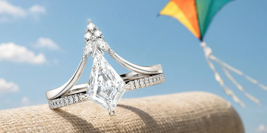 Kite cut diamond engagement ring with split shank band and pavé diamonds against blue sky with colorful kite in background