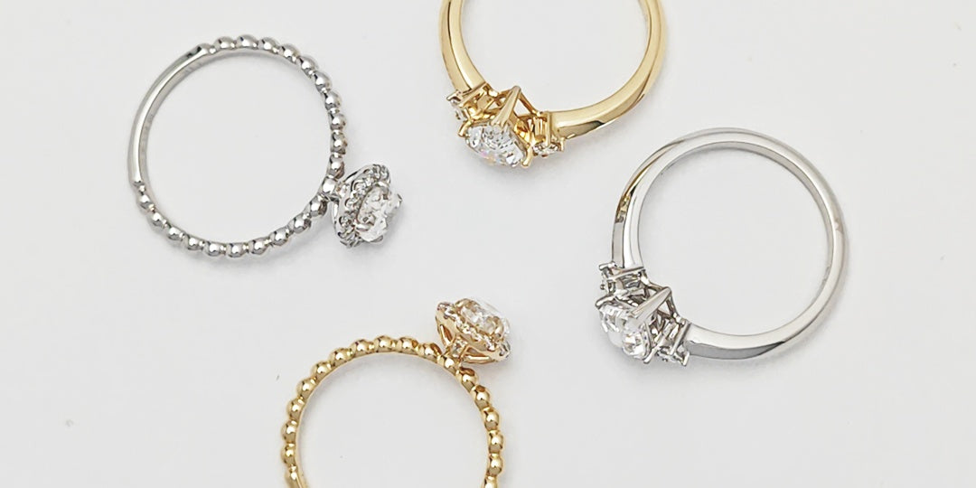 A collection of Moissanite engagement rings in various designs, featuring yellow gold and silver band options with sparkling center stones