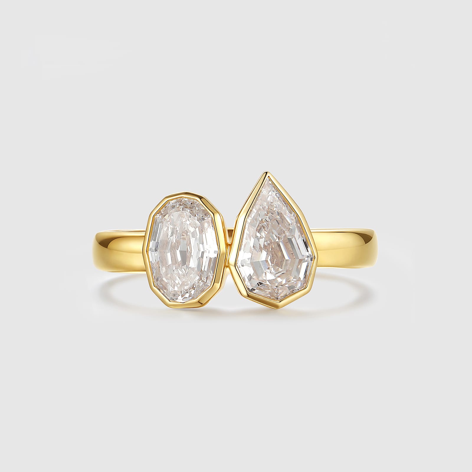 Yellow gold ring with oval and pear cut lab diamonds