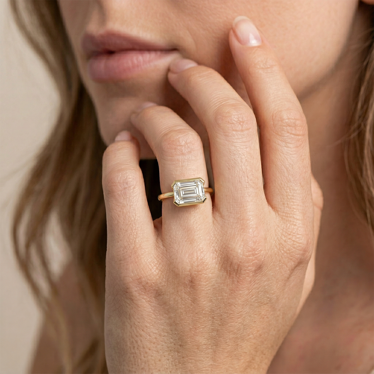 Close-up of a hand wearing a emerald cut diamond ring 