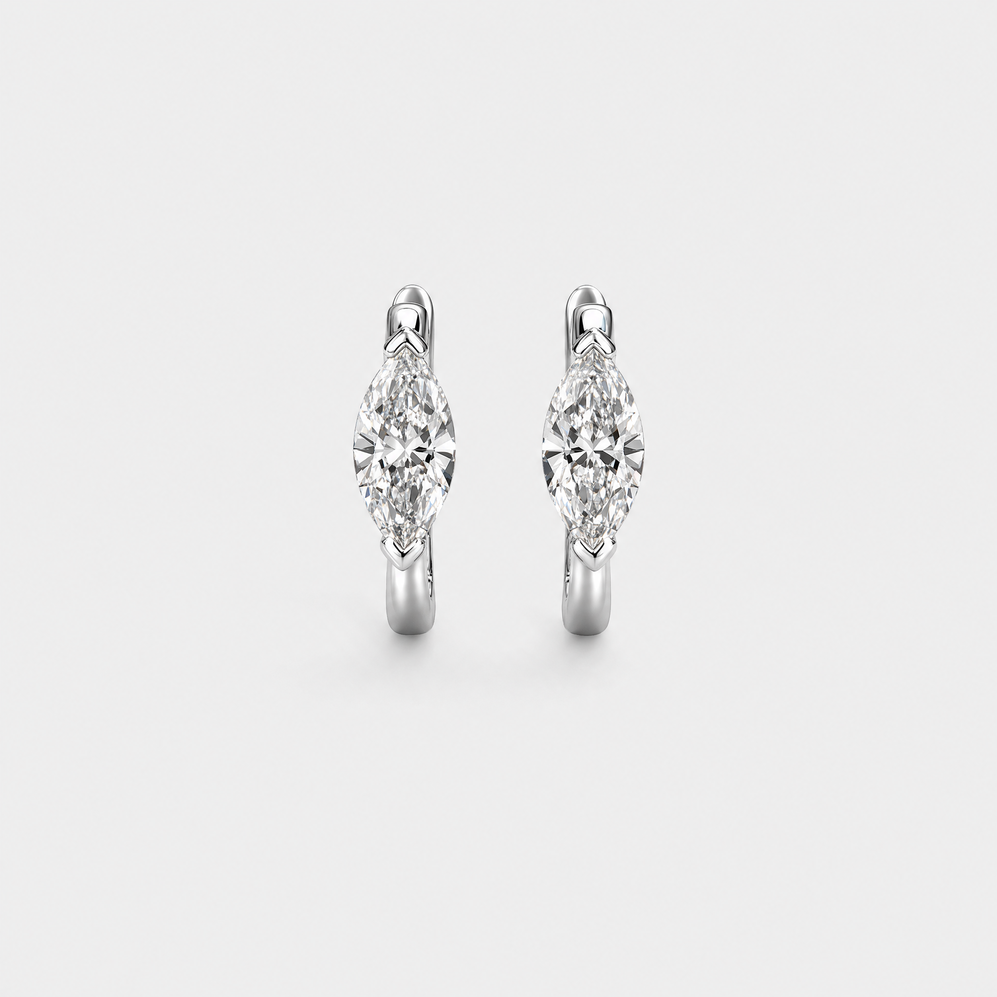 Front view of marquise-cut hoop earrings in white gold on a white background.
