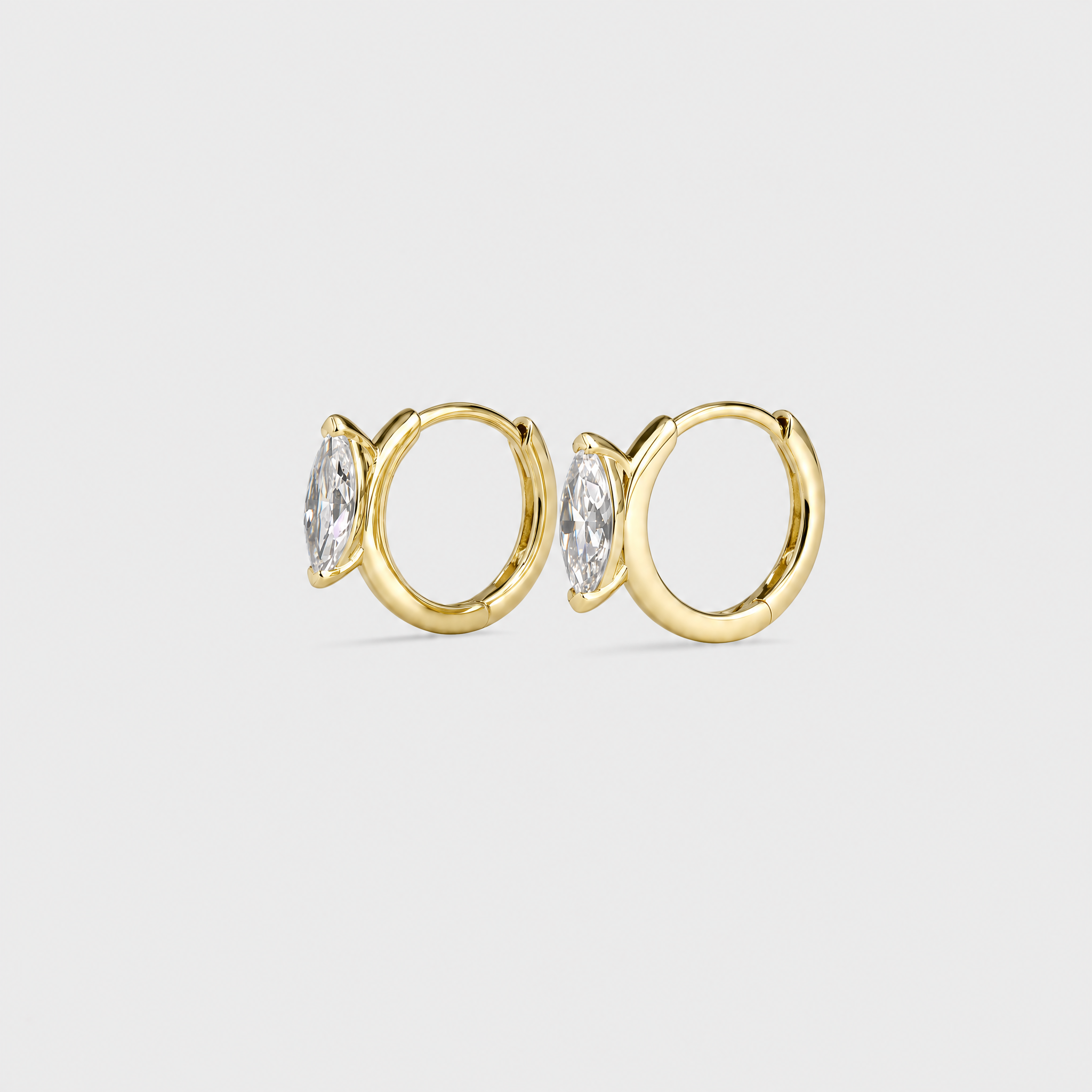 Side view of marquise-cut hoop earrings in yellow gold showing the hinged hoops and stone settings.