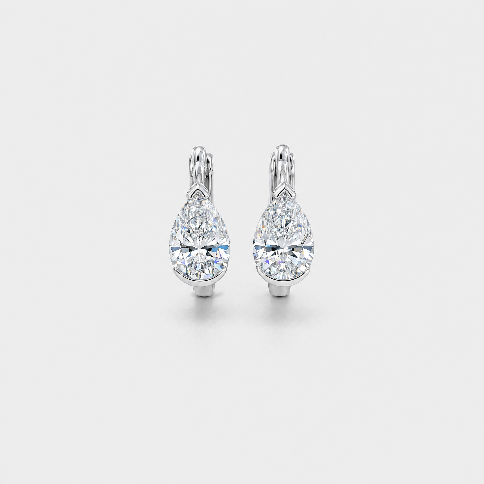 Front view of pear-shaped hoop earrings in white gold on a white background.