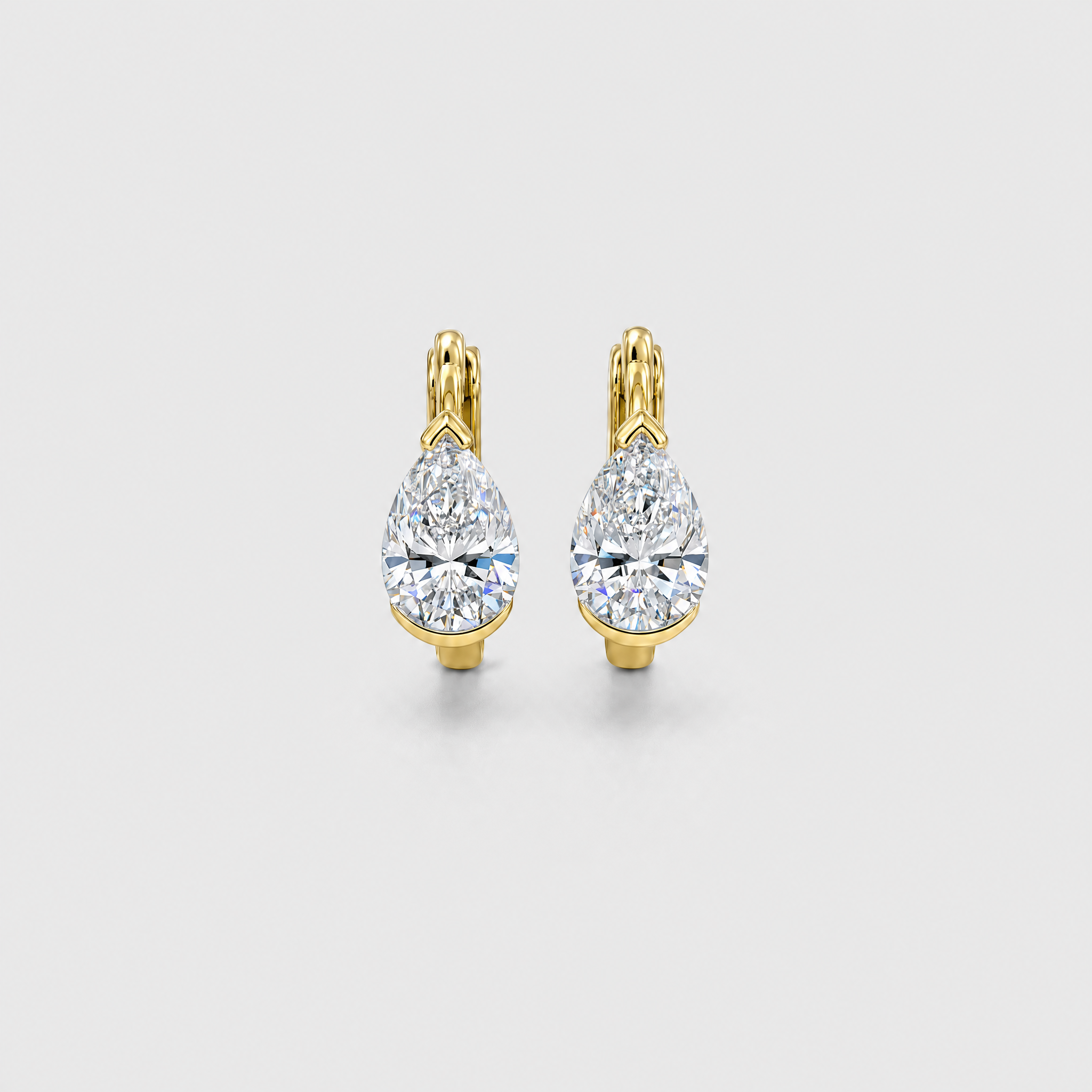 Front view of pear-shaped hoop earrings in yellow gold on a white background.