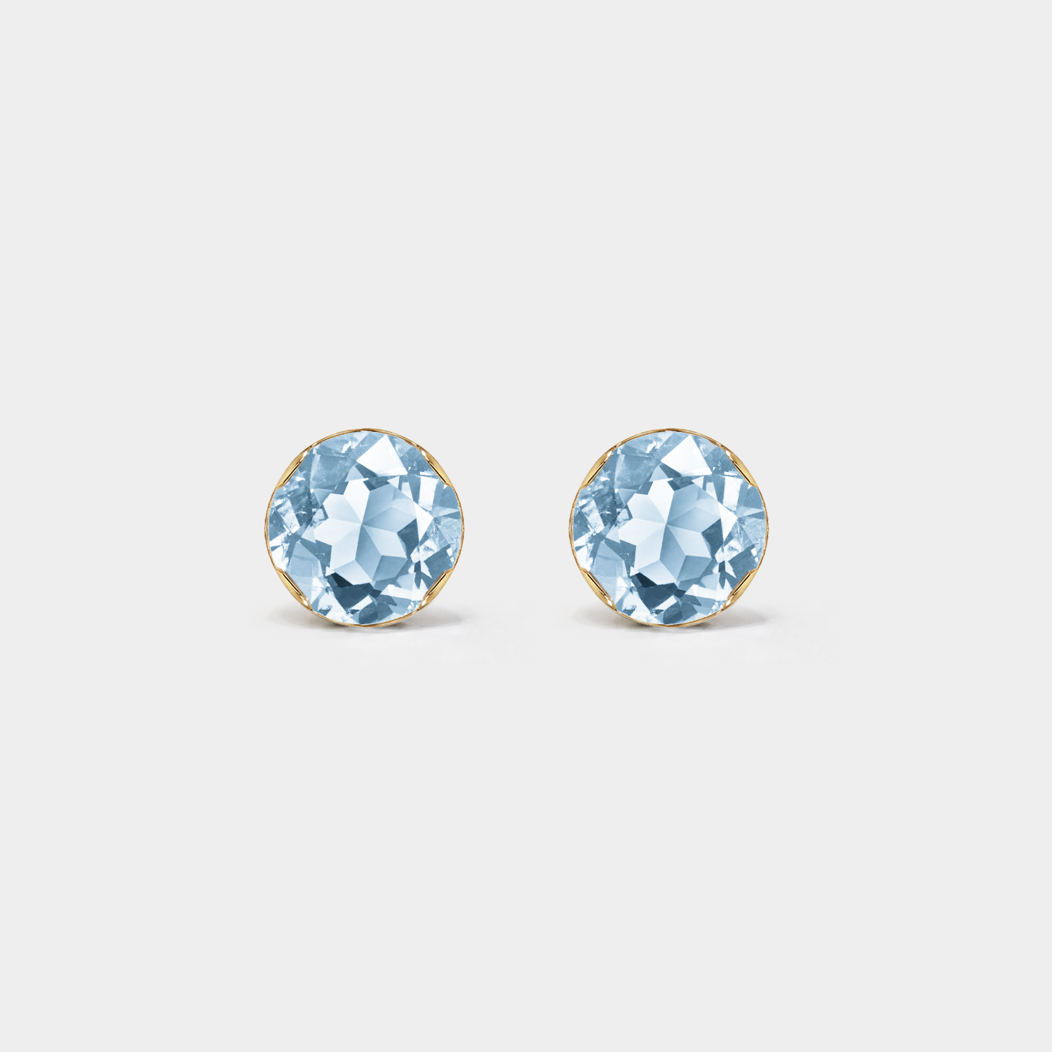 Front view of round lab-grown aquamarine stud earrings in yellow gold on a white background.