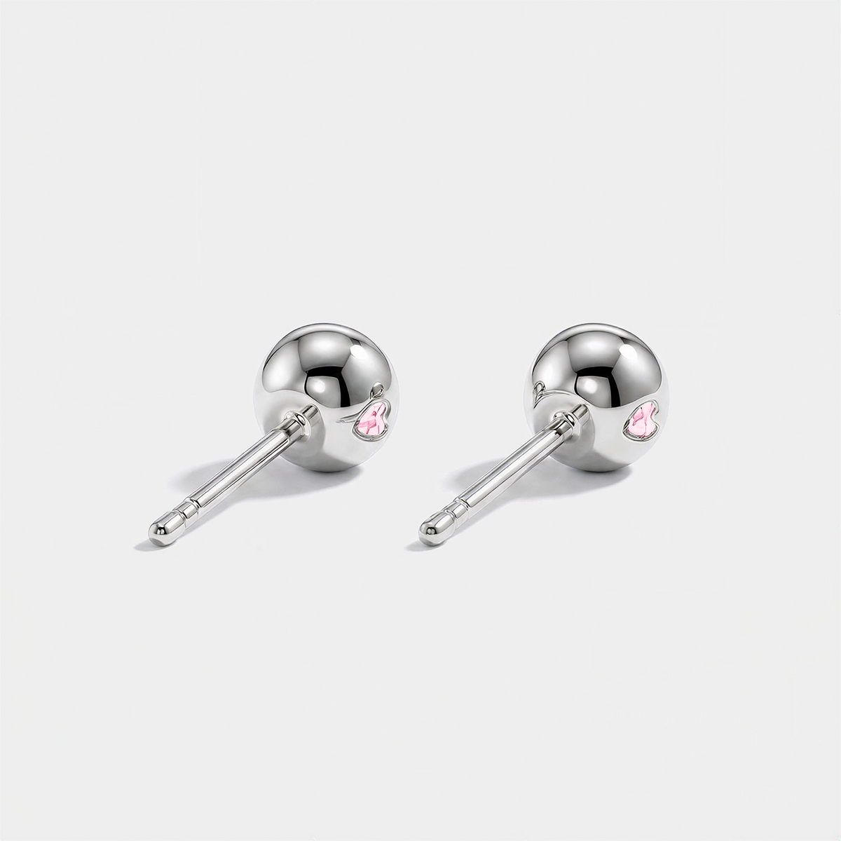 Back view of round pink lab-grown diamond stud earrings with white gold settings and ball backs.