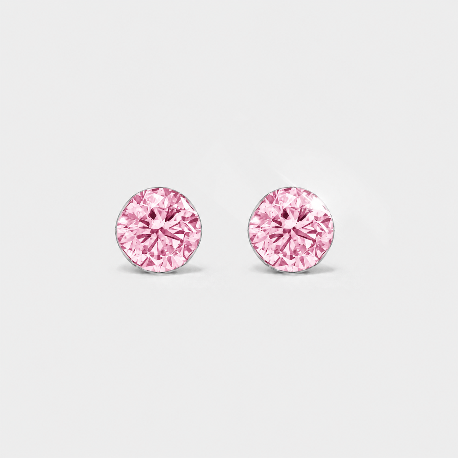 Front view of round pink lab-grown diamond stud earrings in white gold on a white background.