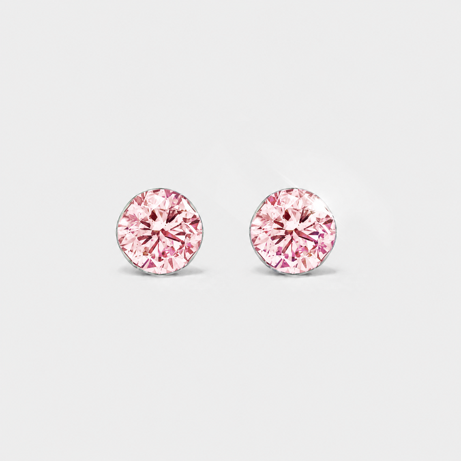 Front view of round pink lab-grown diamond stud earrings in white gold on a white background.