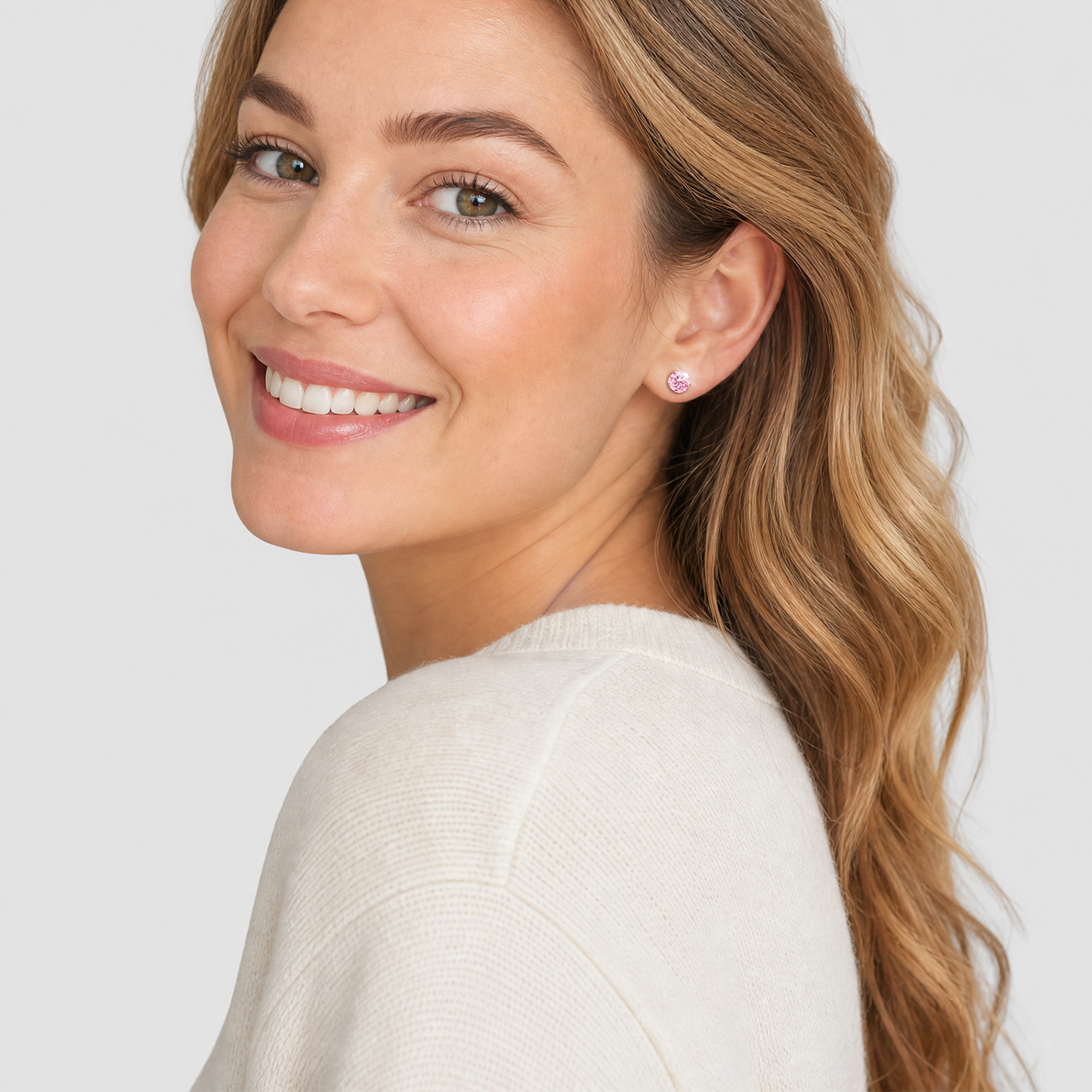 Round pink lab-grown diamond stud earring worn by a model in a bright studio setting.