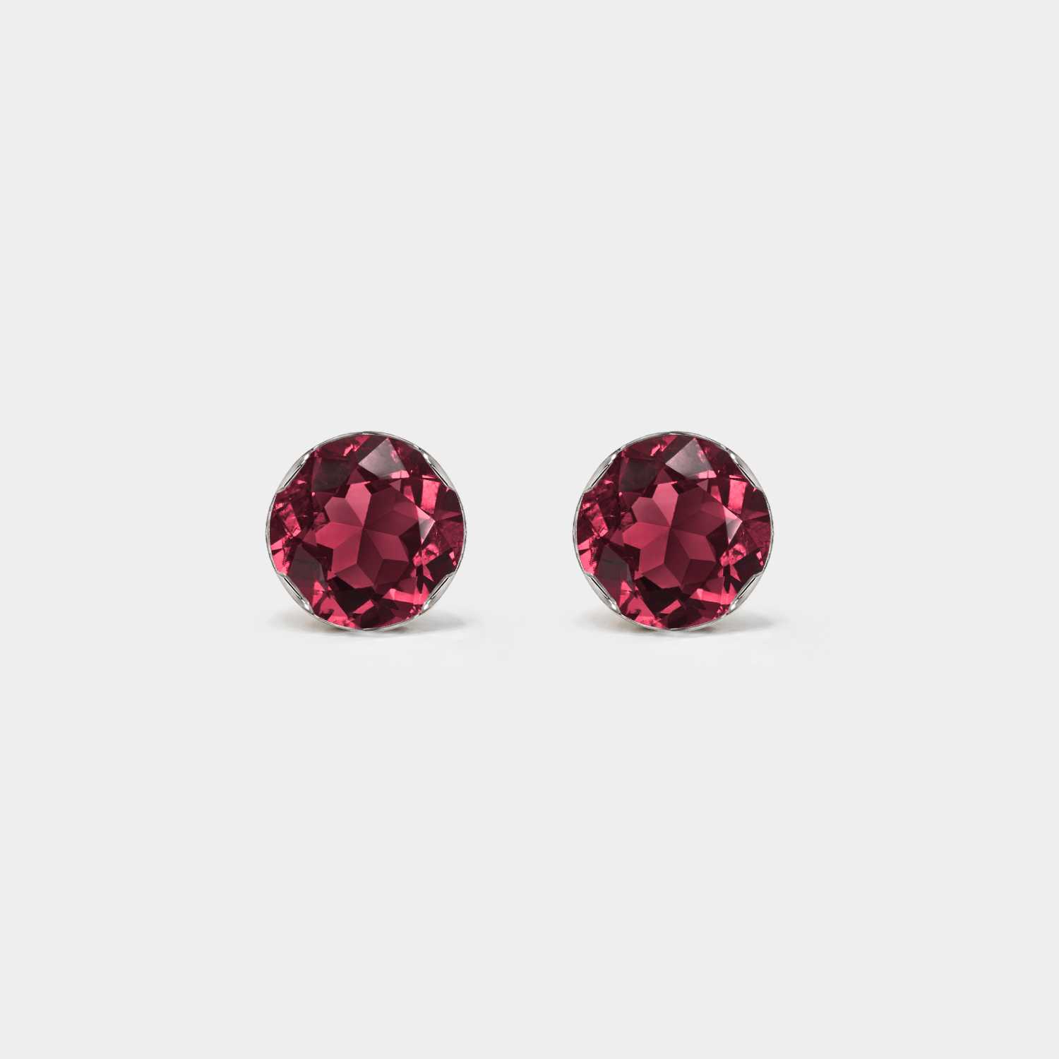 Front view of round lab-grown ruby stud earrings in white gold.