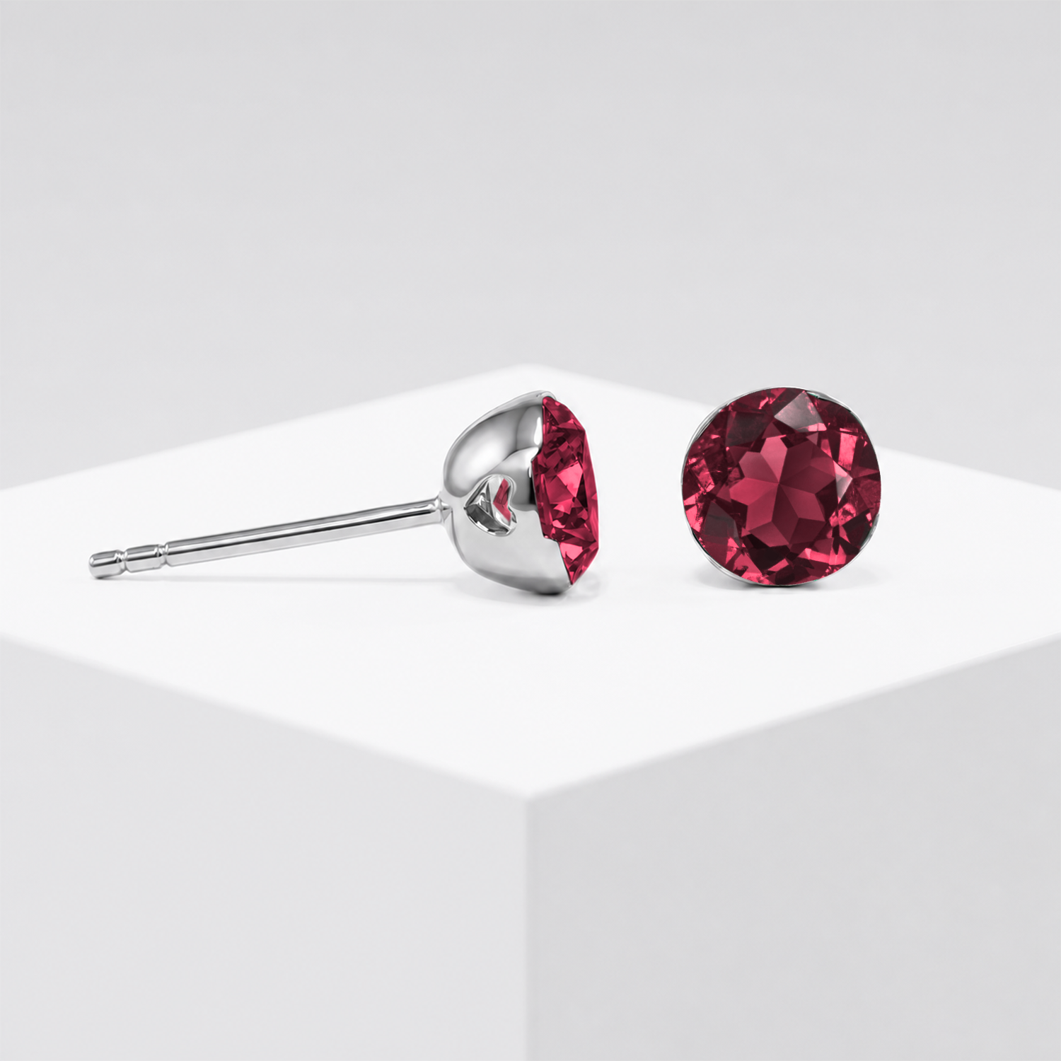 Close-up view of the round lab-grown ruby stud earring setting in white gold.