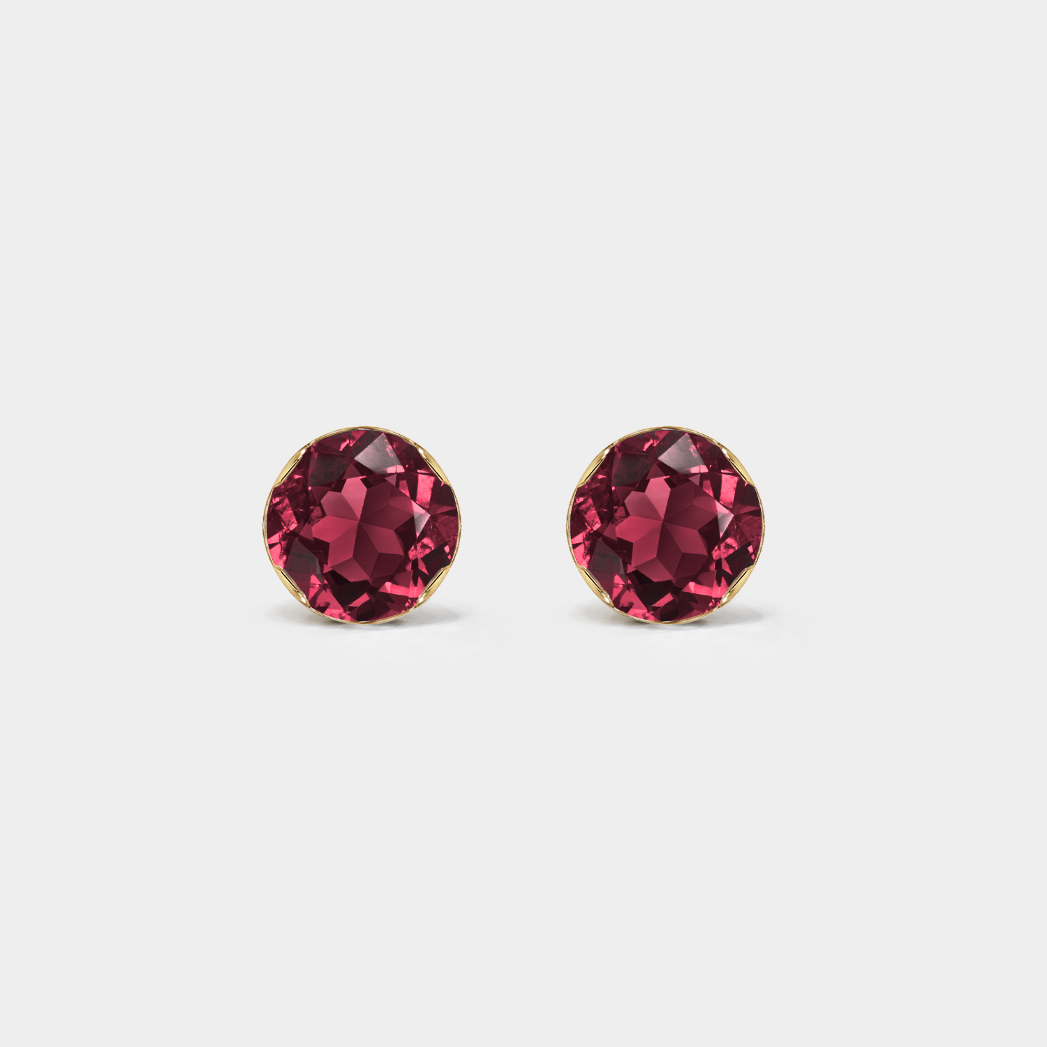 Front view of round lab-grown ruby stud earrings in yellow gold.