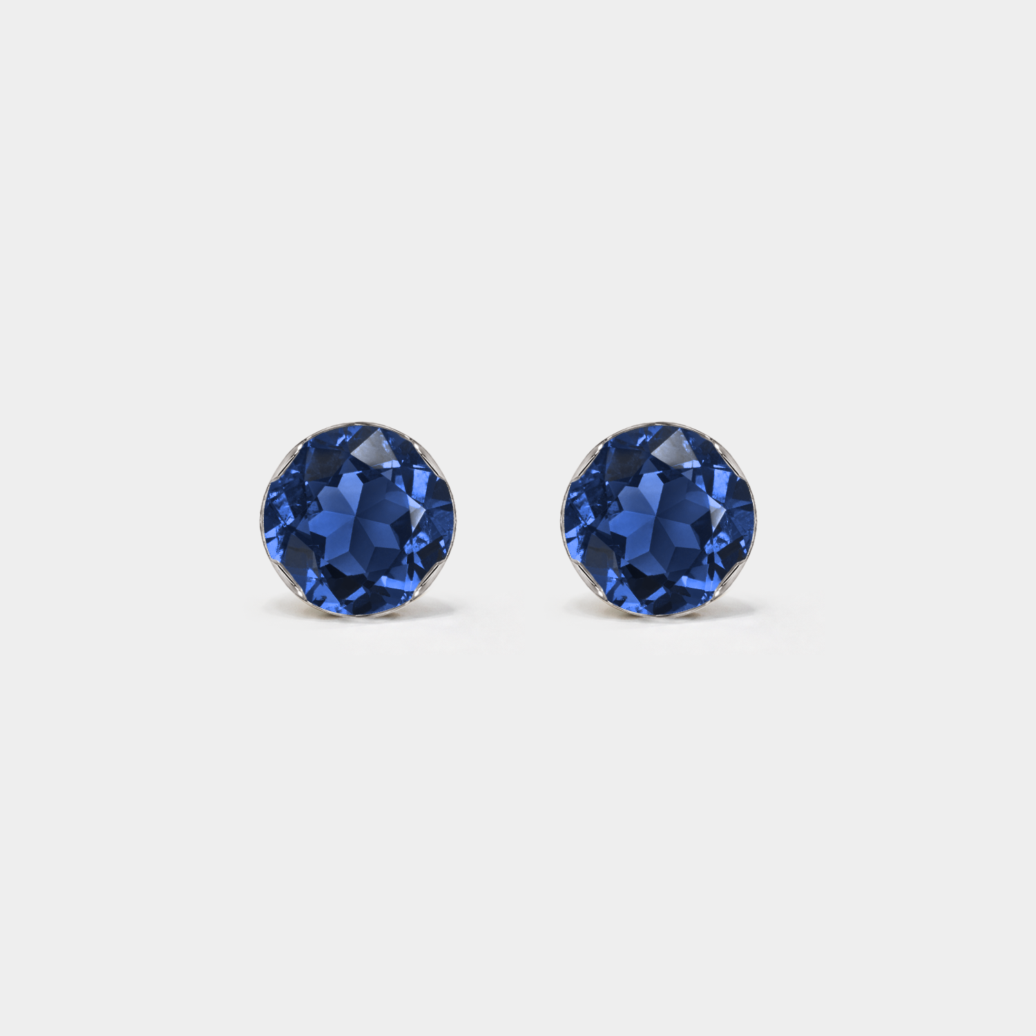 Front view of round lab-grown sapphire stud earrings in white gold on a white background.