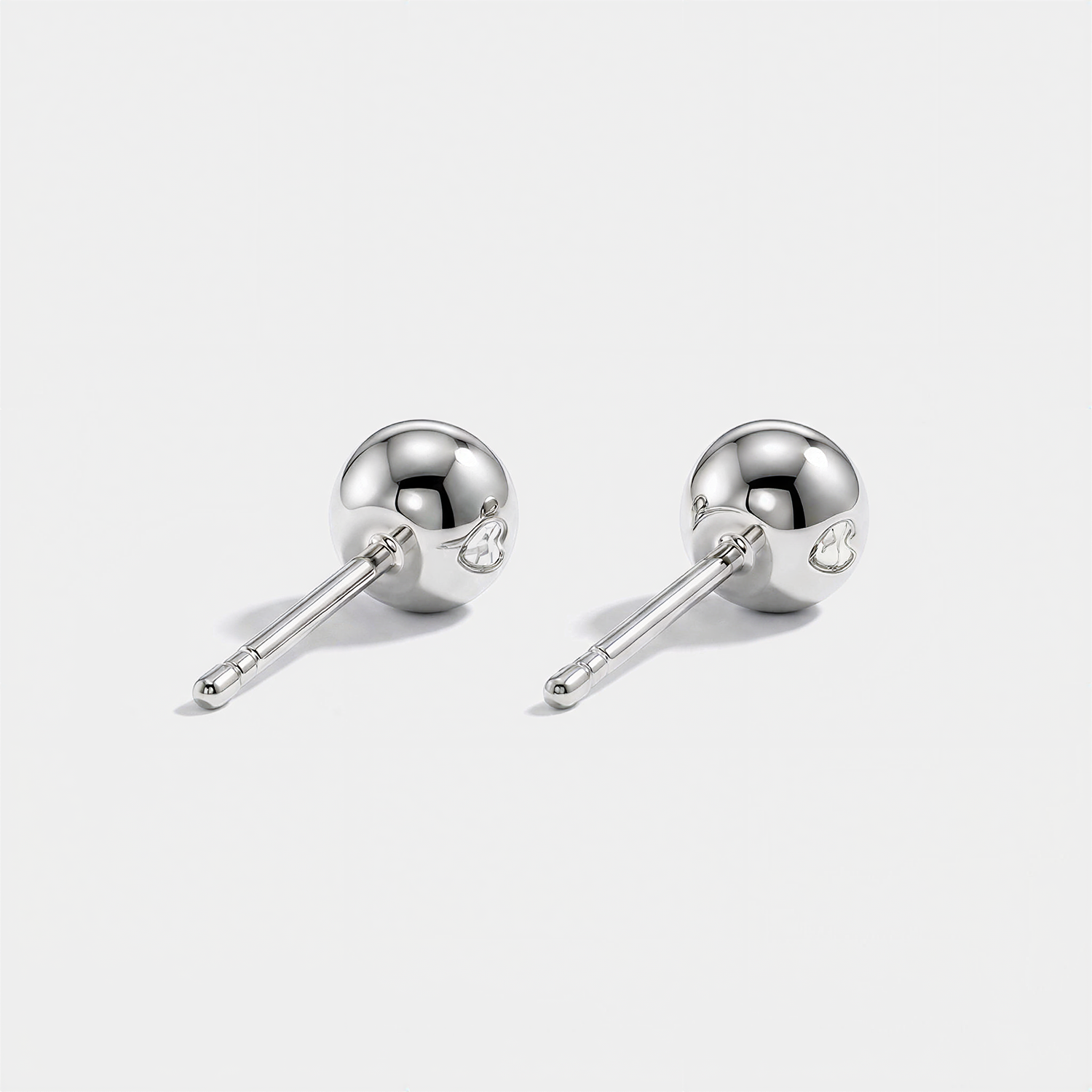 Round stone stud earrings in white metal, back view