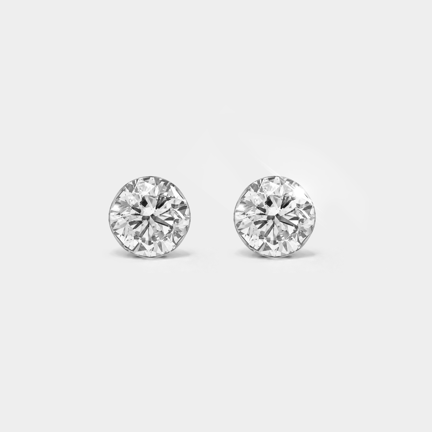 Round stone stud earrings in white metal, front view