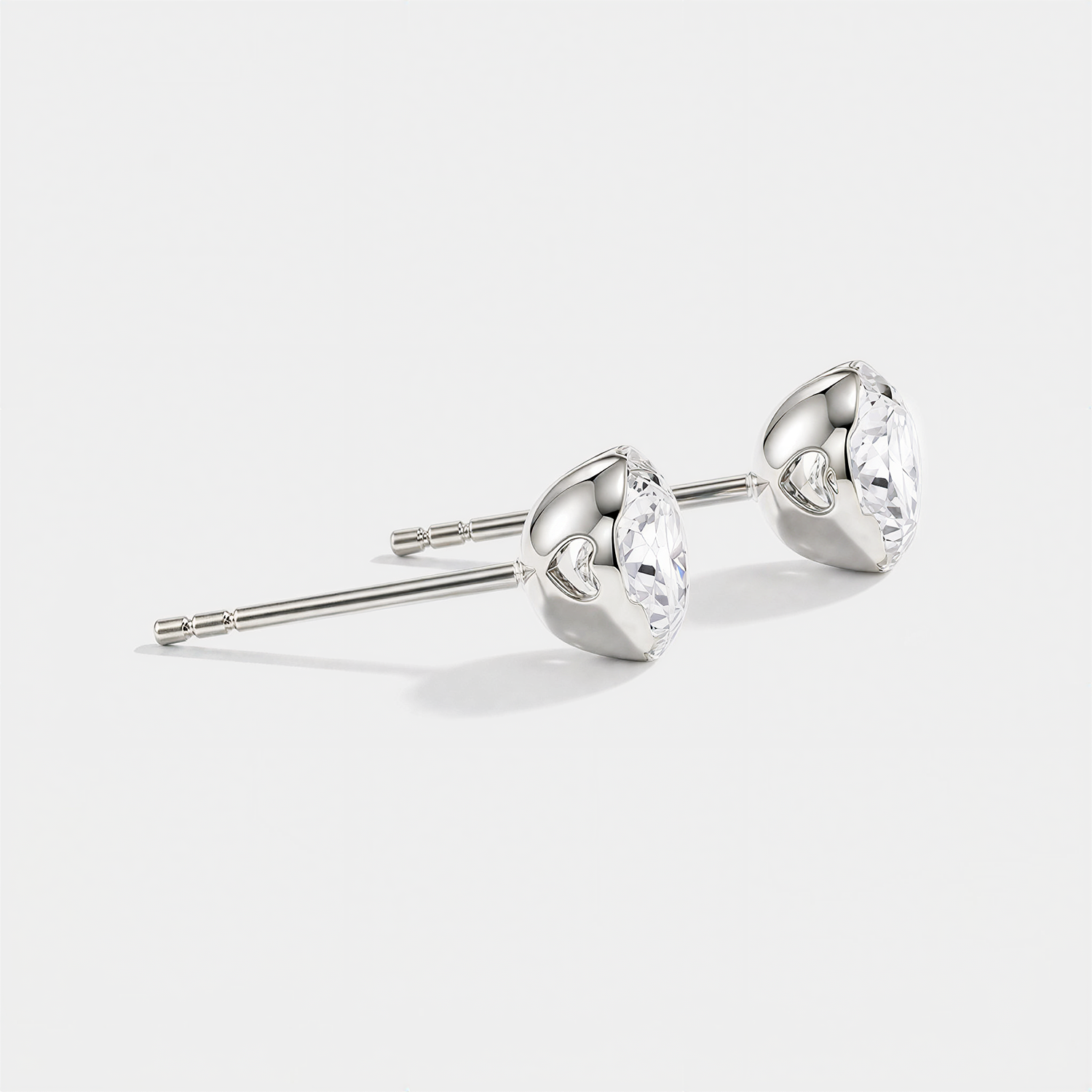 Round stone stud earrings in white metal, side view