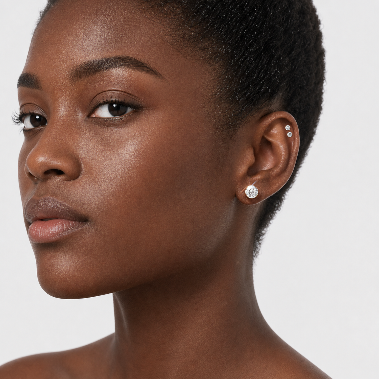 Round stone stud earrings in rose gold worn on the ear