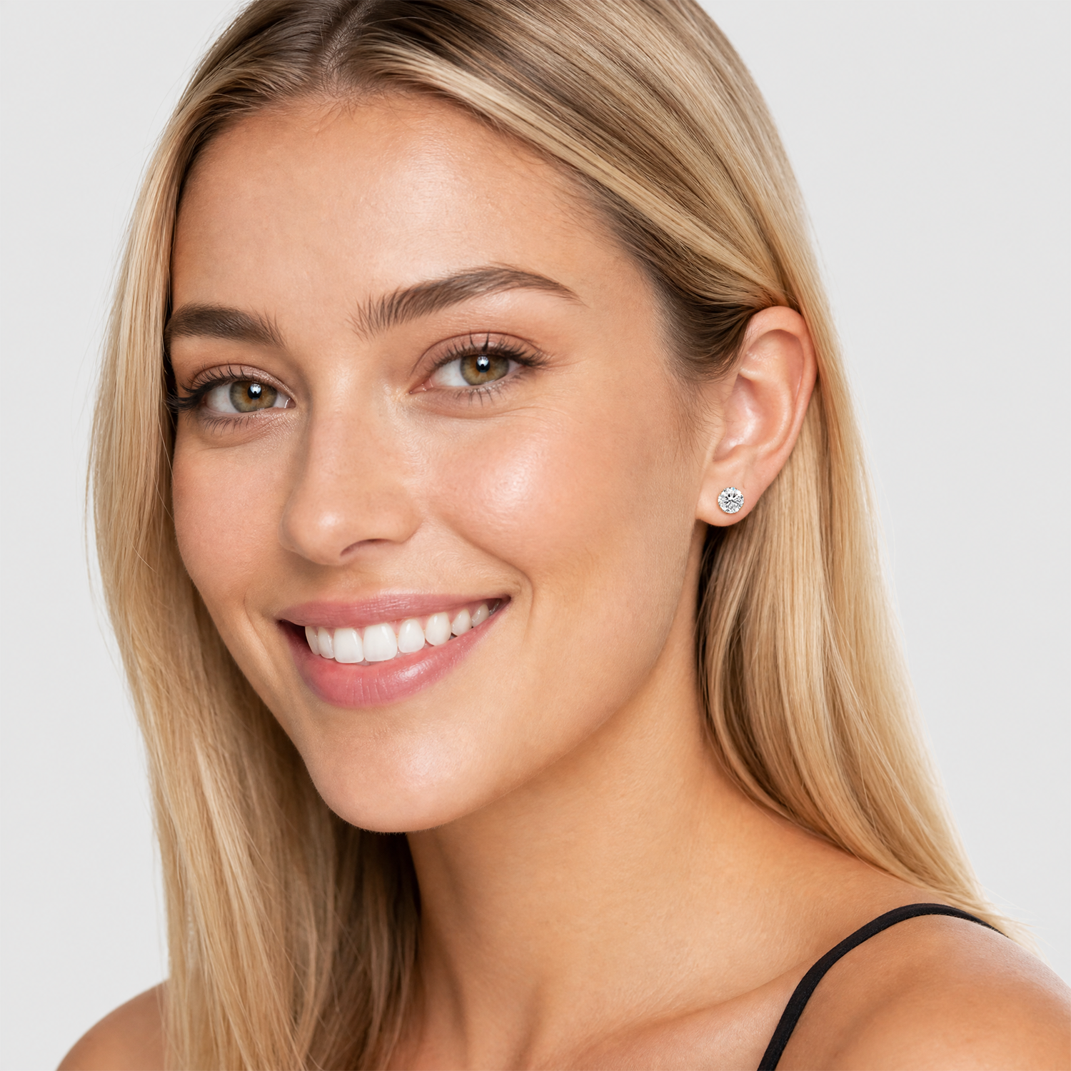 Round stone stud earrings in yellow gold worn on the ear