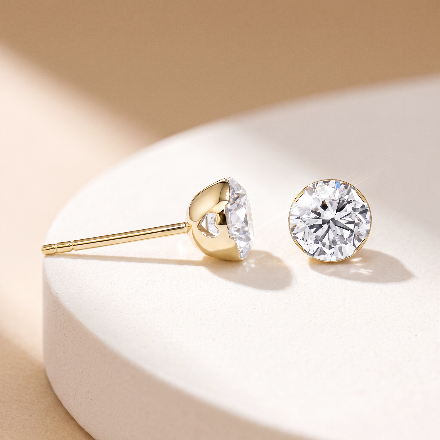 Yellow gold round stone stud earrings in a jewelry setting
